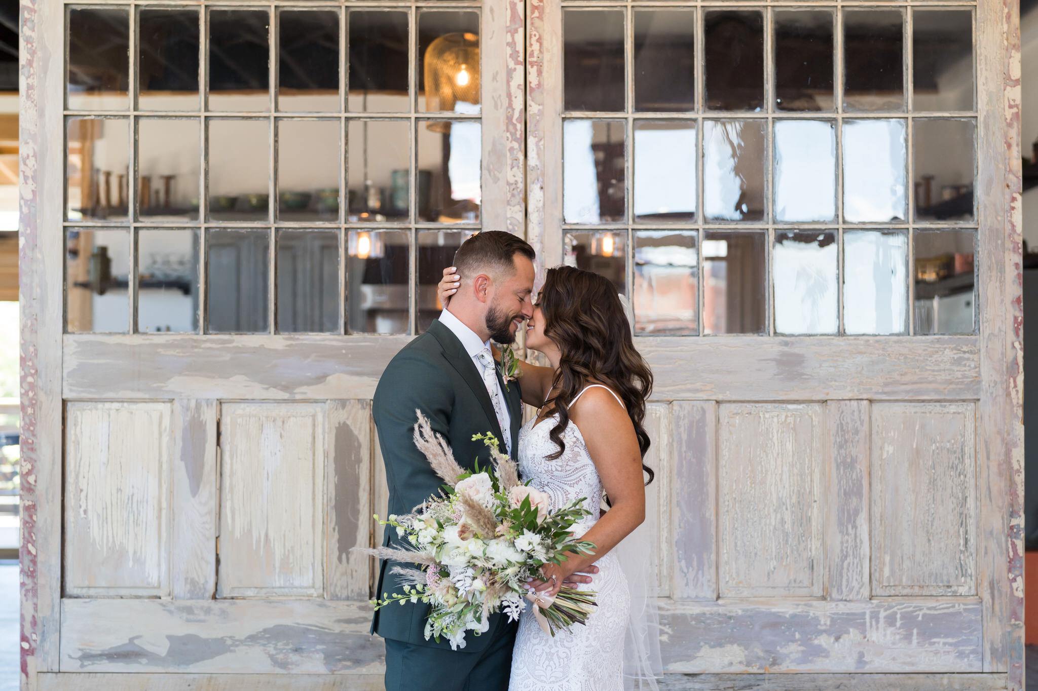 bride and groom almost kiss during a first look at their Holly Vault wedding