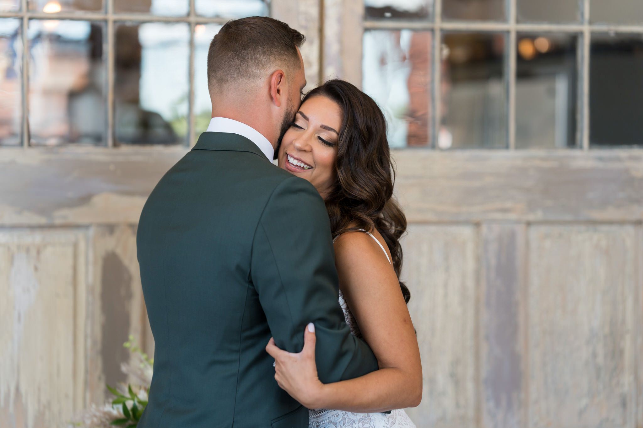 bride and groom hug during a first look at their Holly Vault wedding