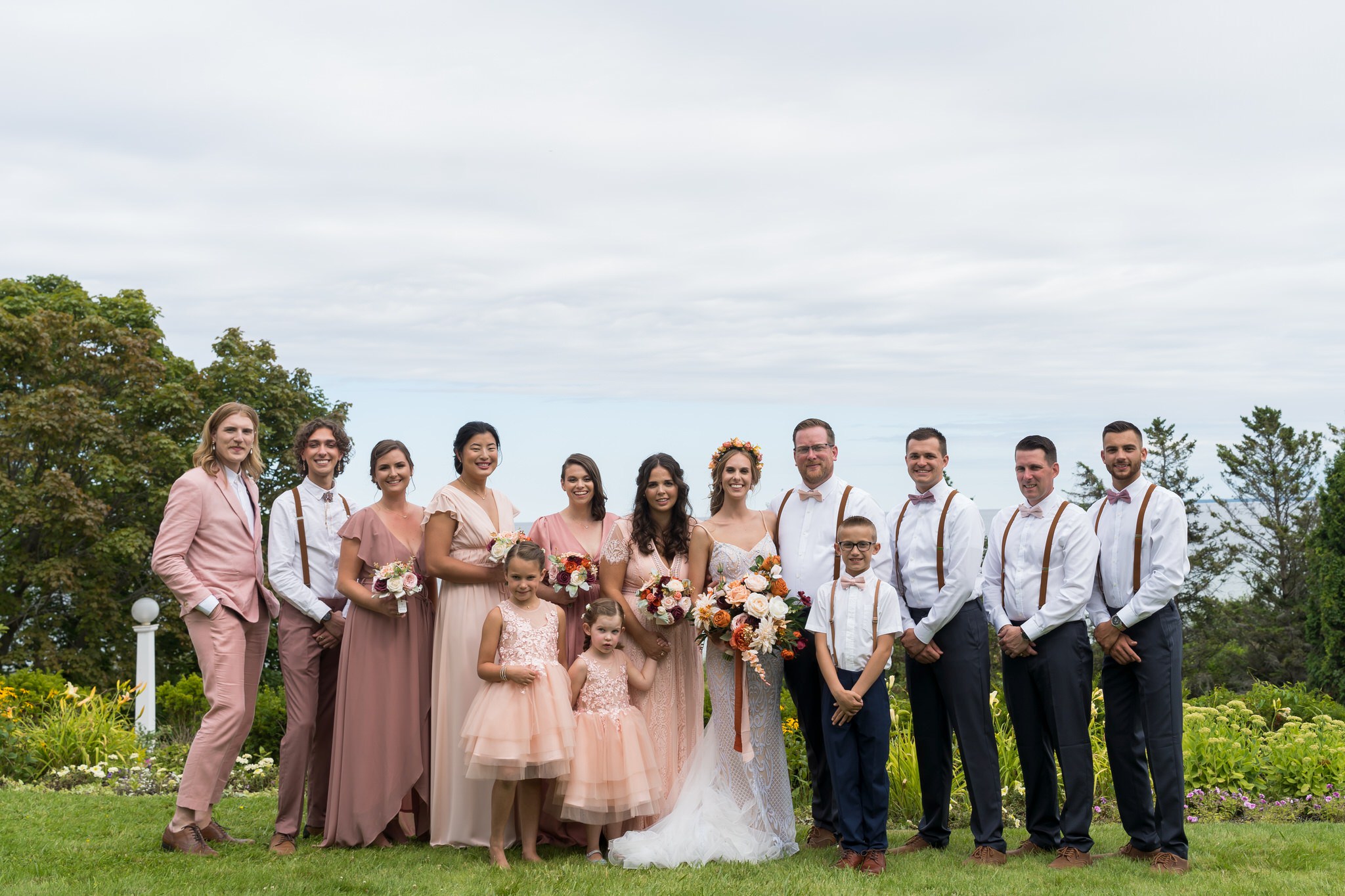 A bridal party poses at Mission Point Resort wedding on Mackinac Island.