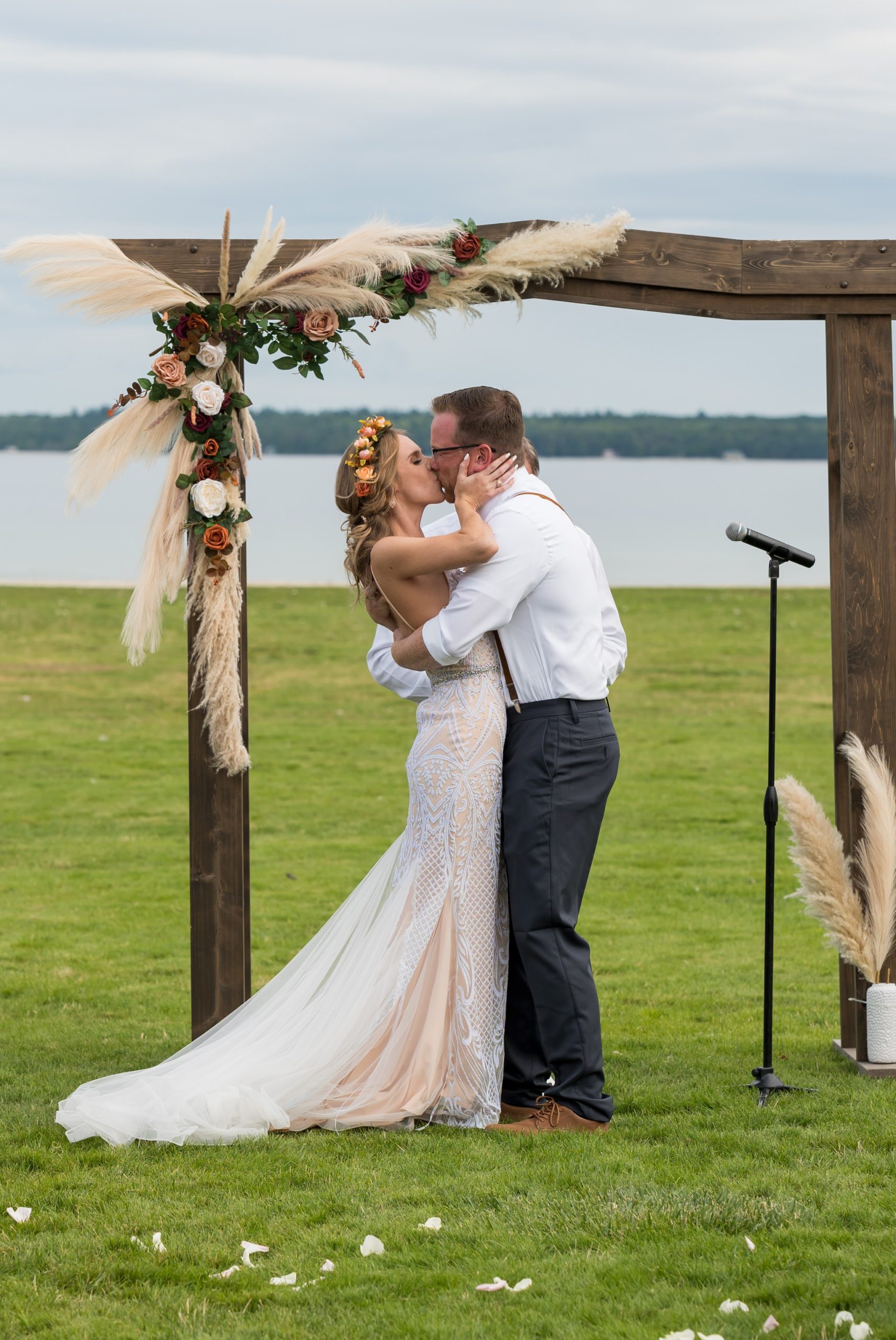 A bride and groom kiss as they are announced as husband and wife during their Mission Point Resort wedding.