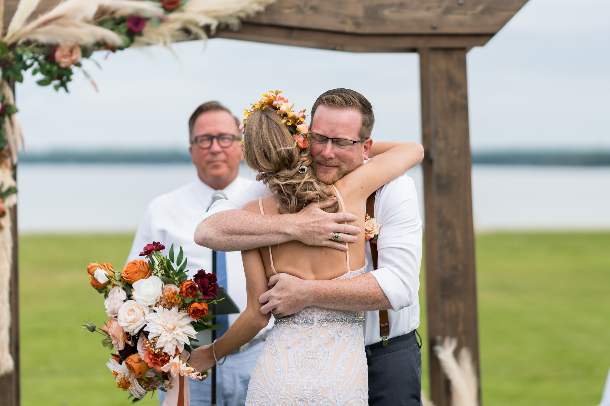 A bride and groom hug during their Mission Pointe Resort wedding ceremony.  