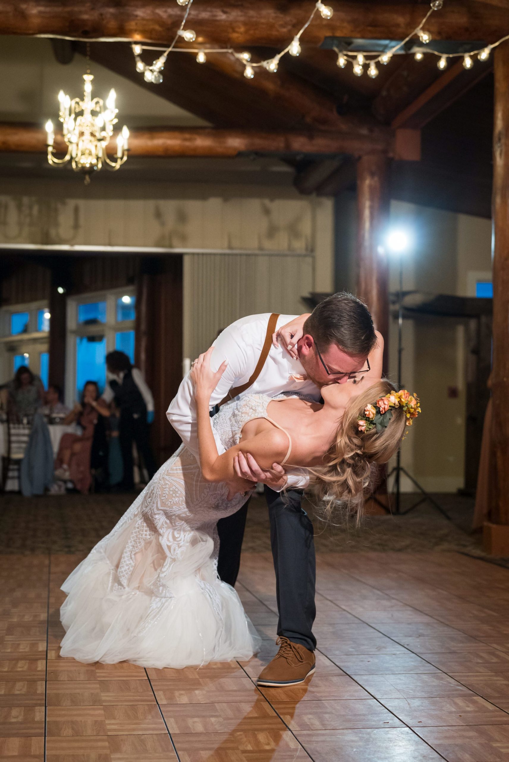 A bride and groom dip and kiss during their first dance at a Mission Pointe Resort wedding. 