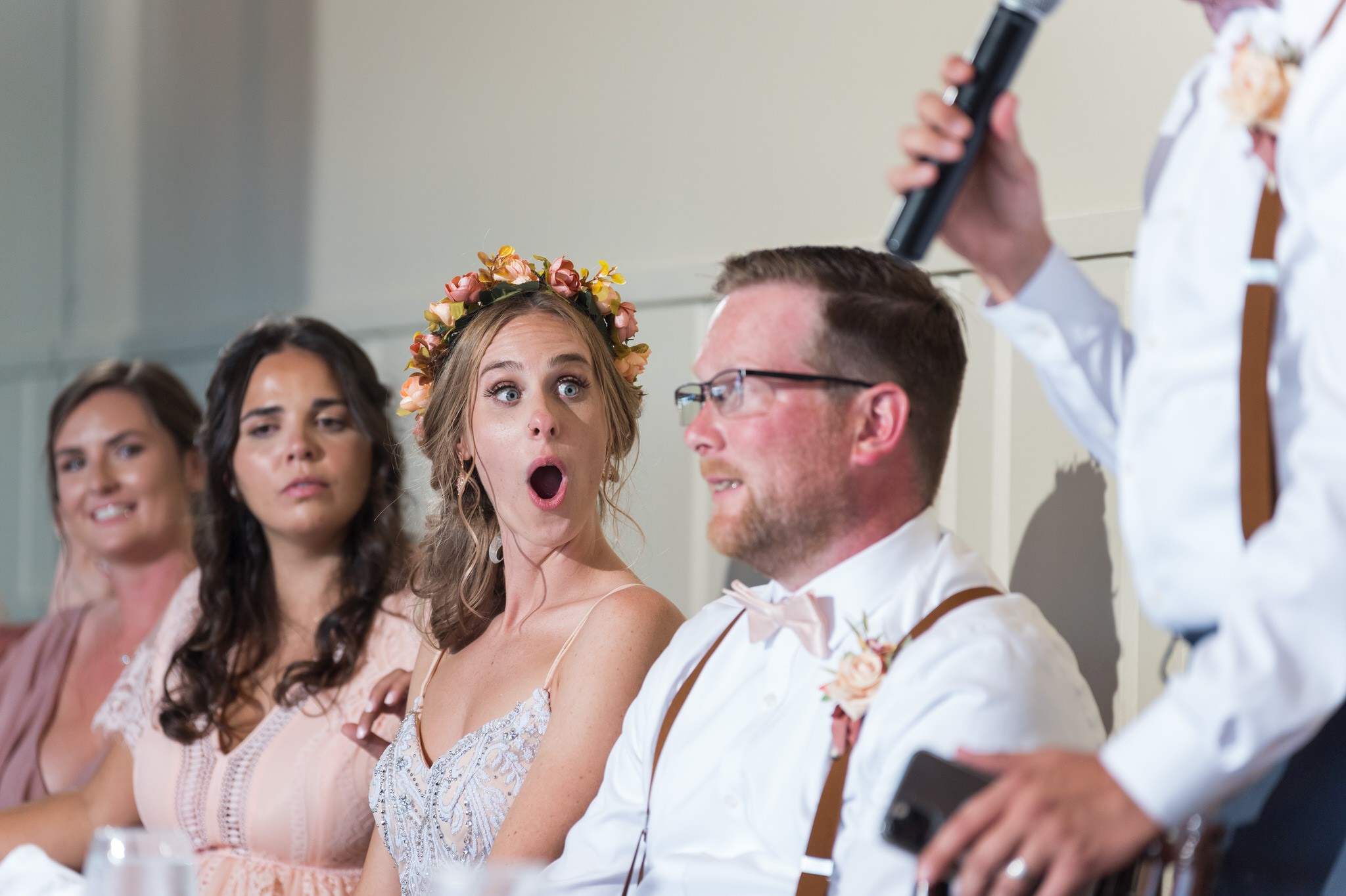 A bride reacts to speeches during their Mission Pointe Resort wedding.  