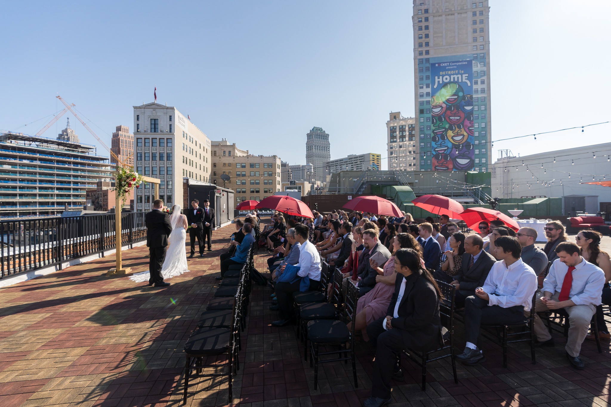 A crowd watches a rooftop wedding at Detroit Opera House.