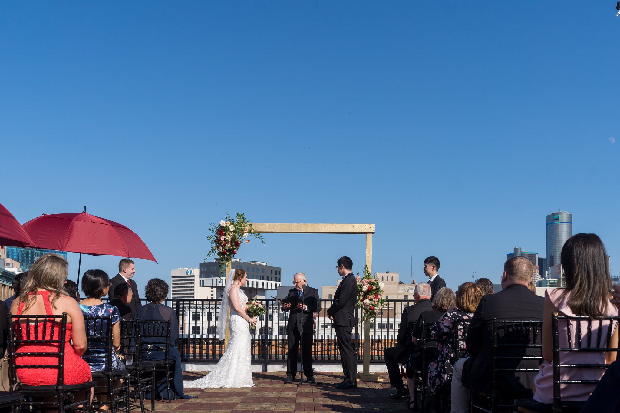 A bride and groom share vows at their rooftop wedding at Detroit Opera House. 