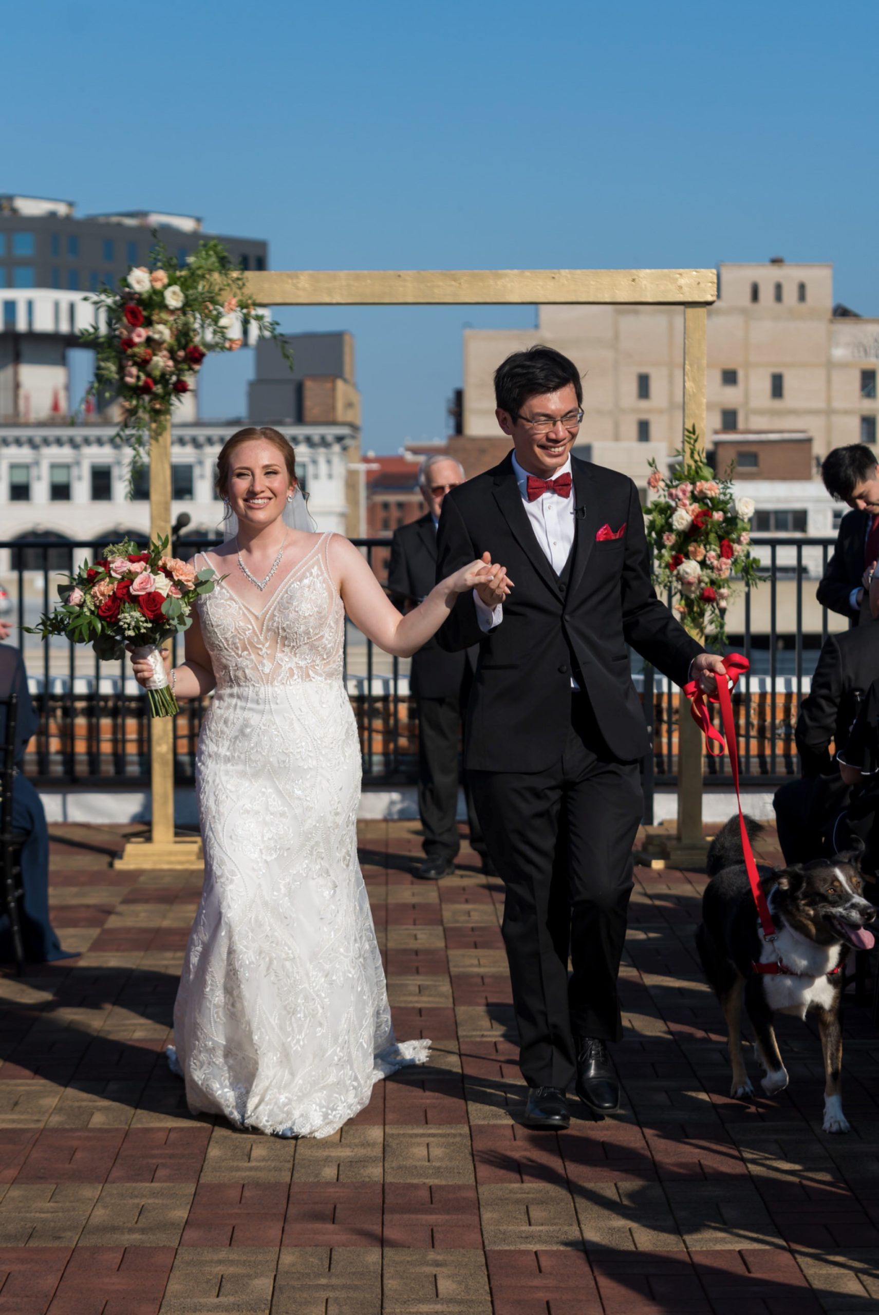 A bride and groom walk down the aisle at their rooftop wedding at Detroit Opera House. 