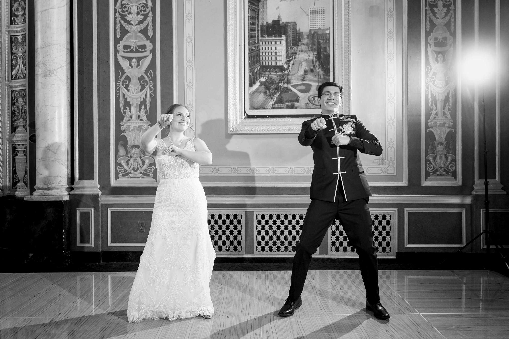 A black and white photo of a bride being dancing at their Detroit Opera House wedding. 