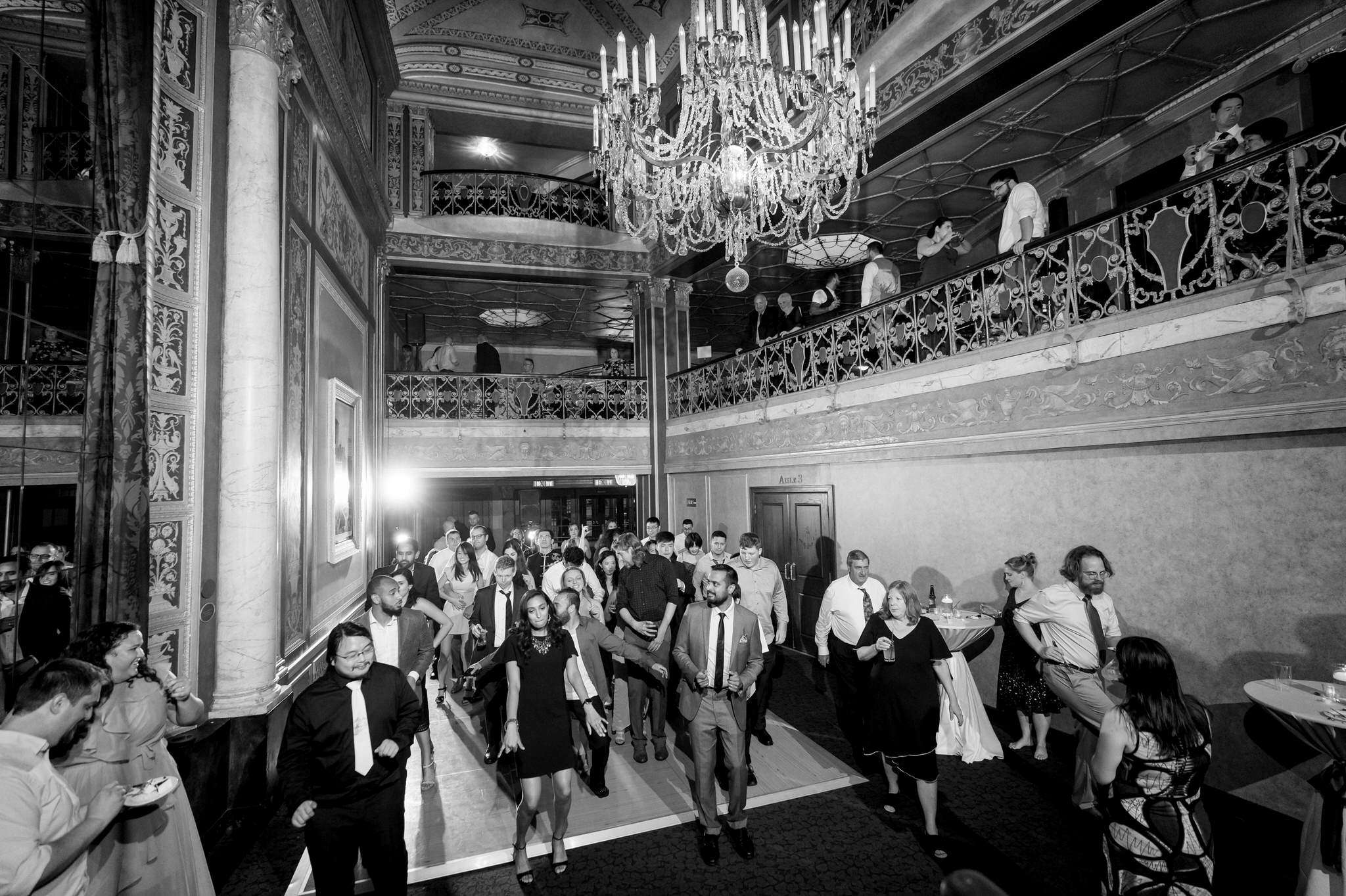 A black and white, wide angle photo of a packed dance floor in Detroit Opera House. 