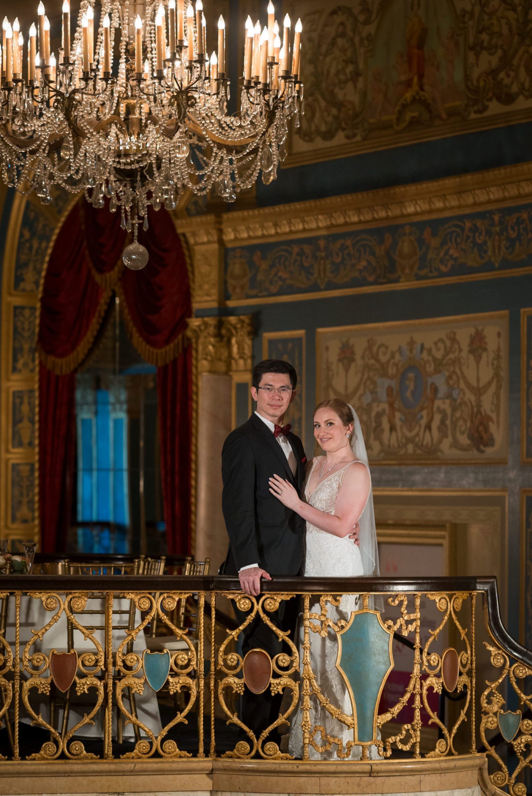 A bride and groom pose on the grand staircase at the Detroit Opera House. 