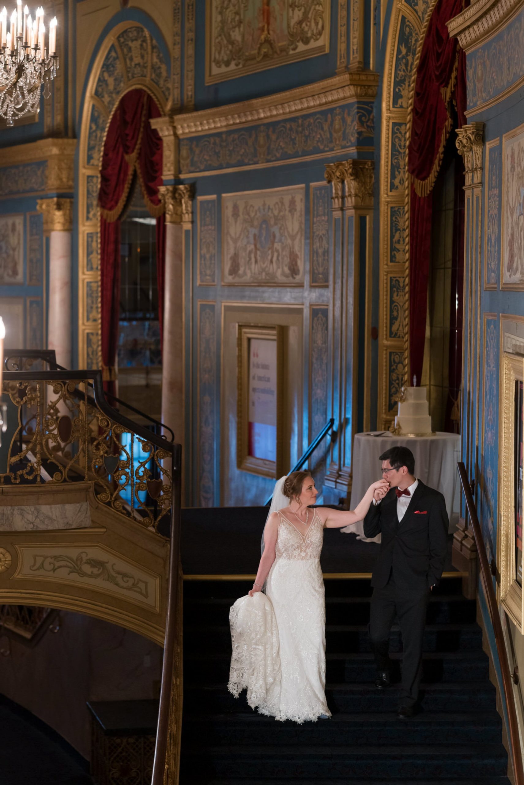 A bride and groom walk down the grand staircase at the Detroit Opera House. 