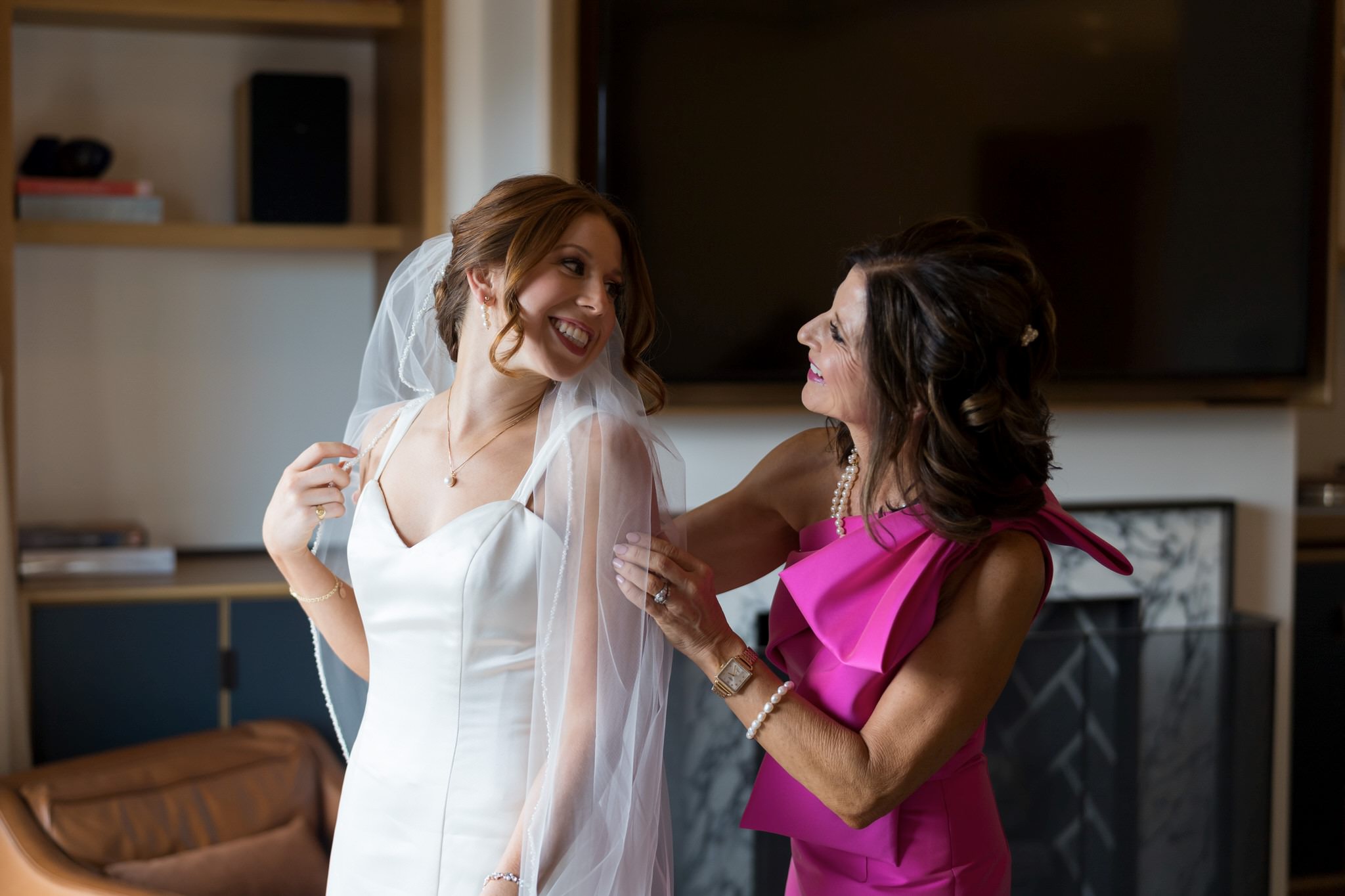 A mom helps her daughter put on her veil on her wedding day in Shinola Hotel in Detroit.  