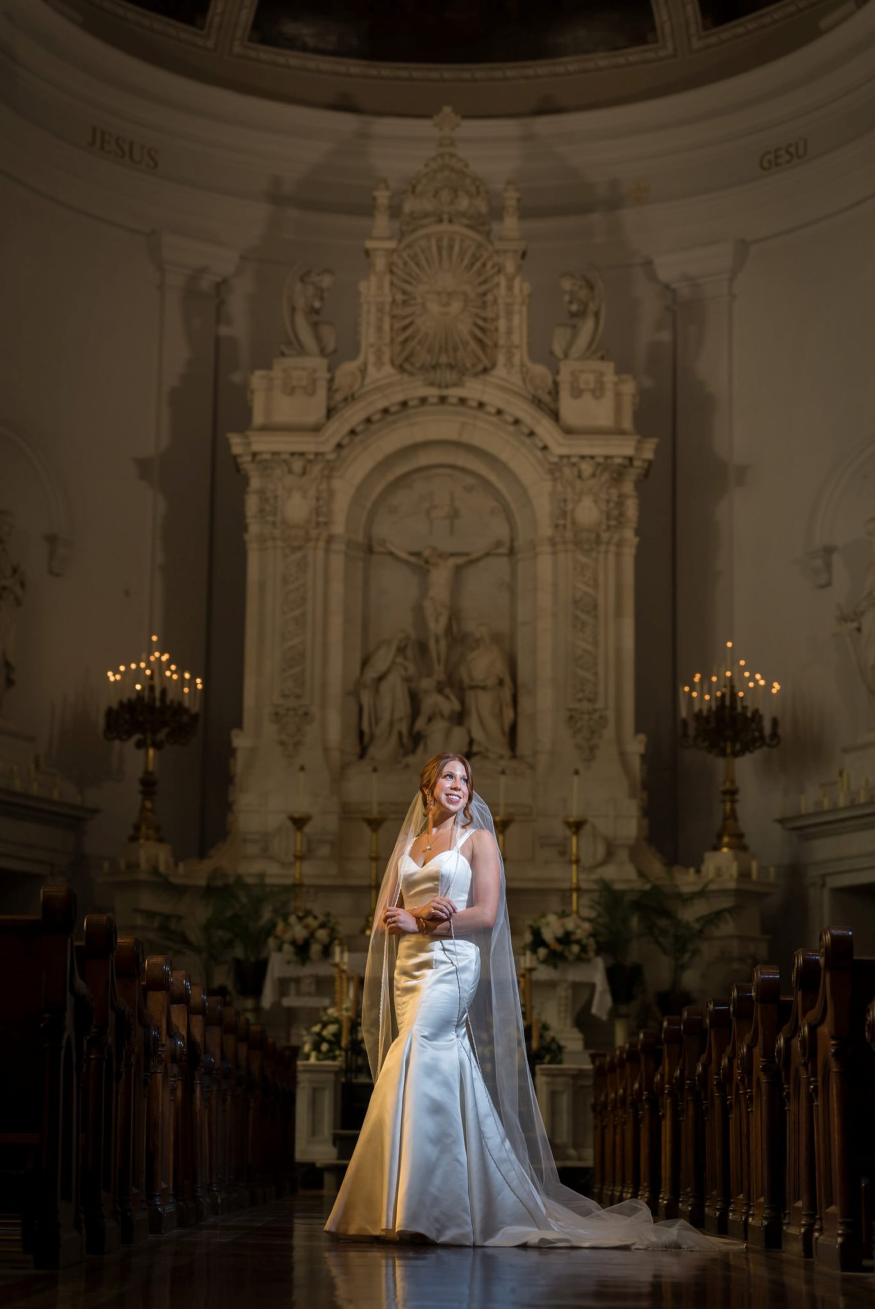 A bride stands alone in the center aisle of Sts. Peter and Paul Jesuit church in Detroit. 