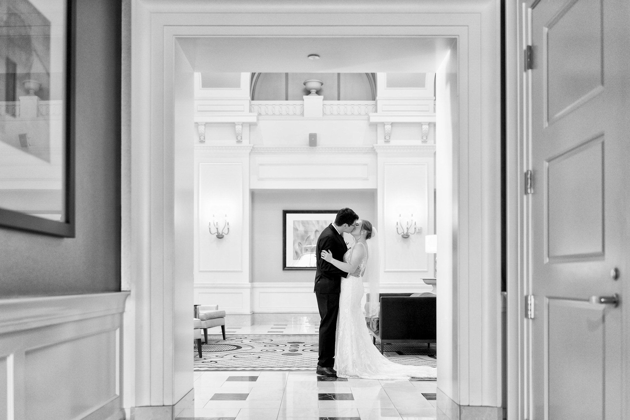 A bride and groom kiss during their first look in the Venetian Room at the Westin Book Cadillac. 