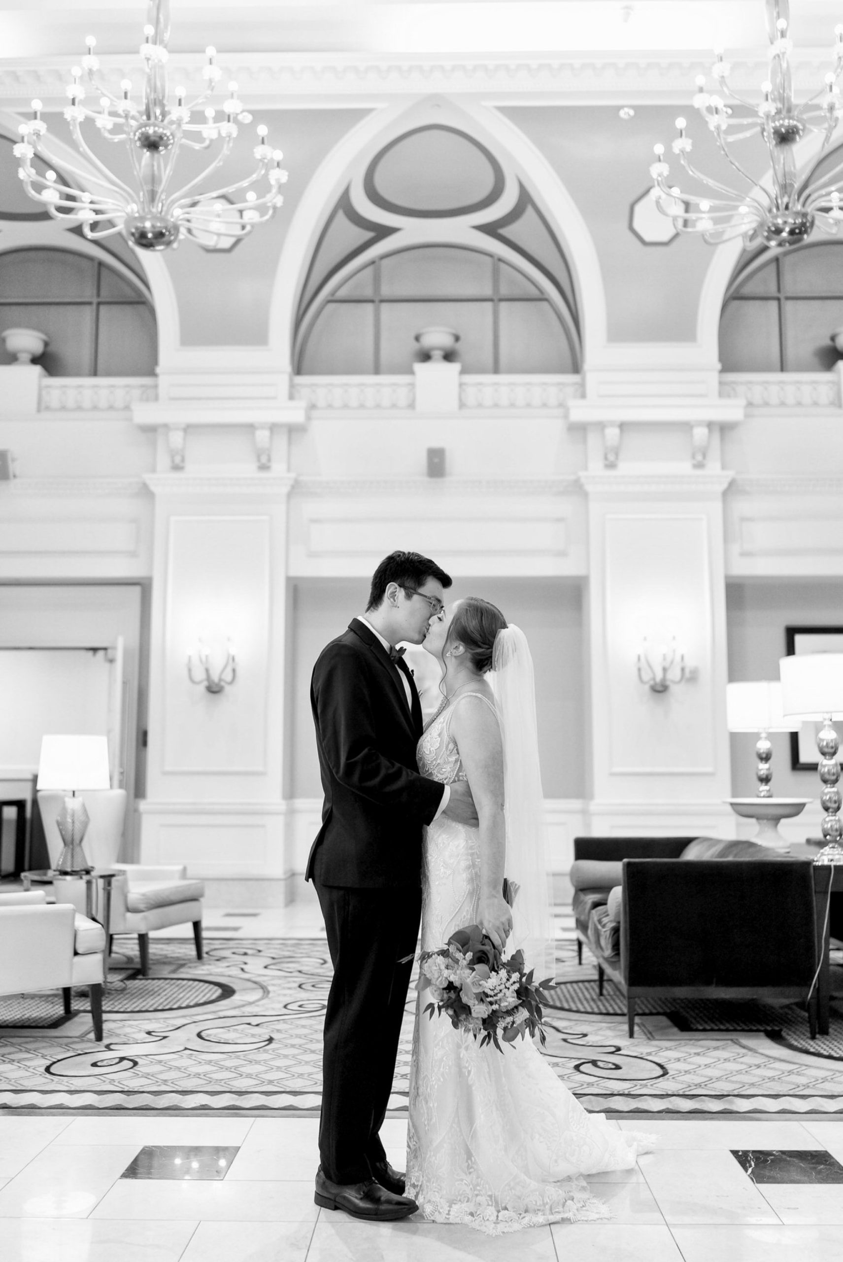 A bride and groom kiss in the Venetian Room at the Westin Book Cadillac. 