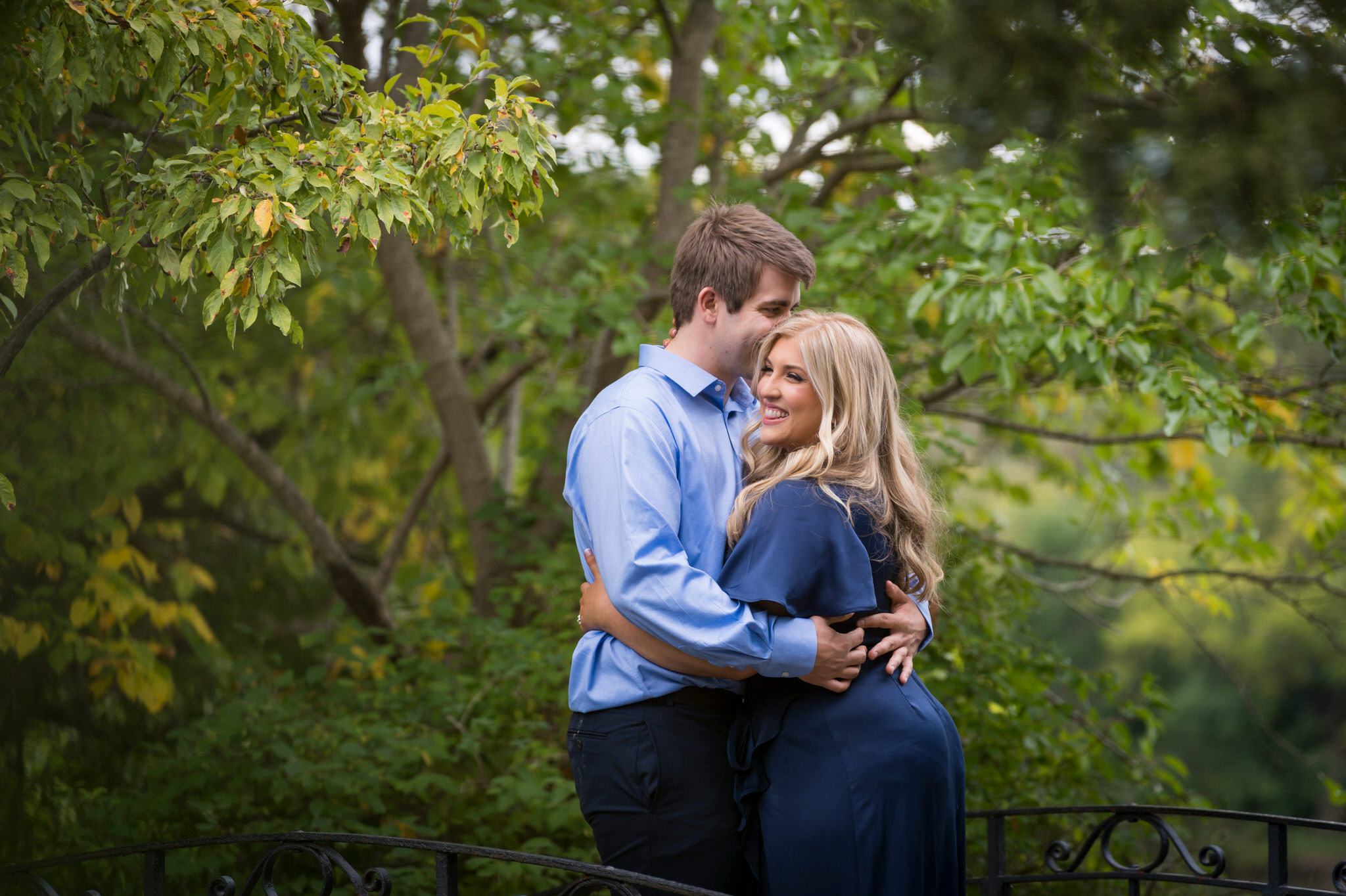 A couple embrace and hug during their Cranbrook engagement session.  