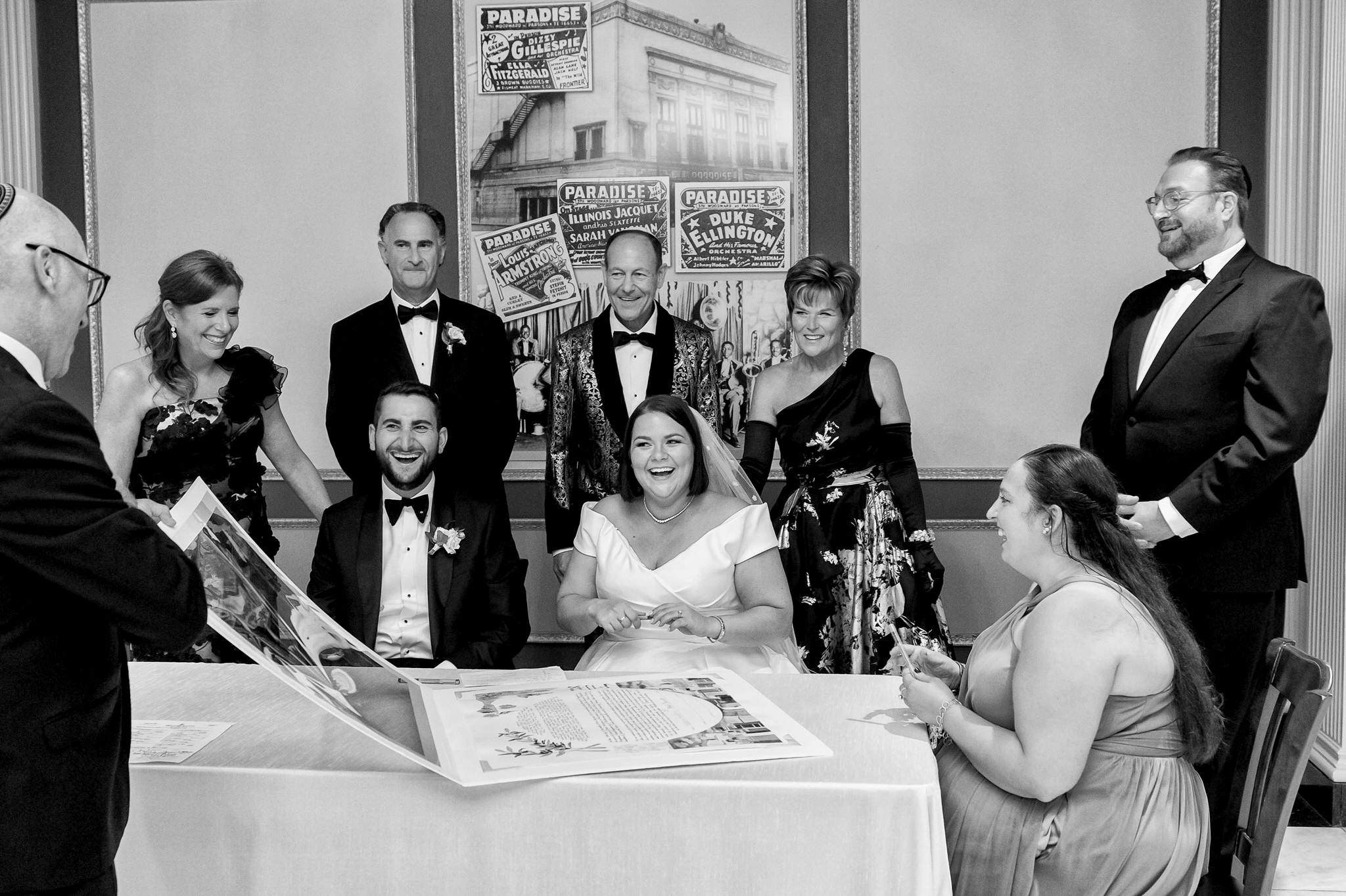 A Jewish ketubah signing takes place during a Jewish Detroit Orchestra Hall wedding.