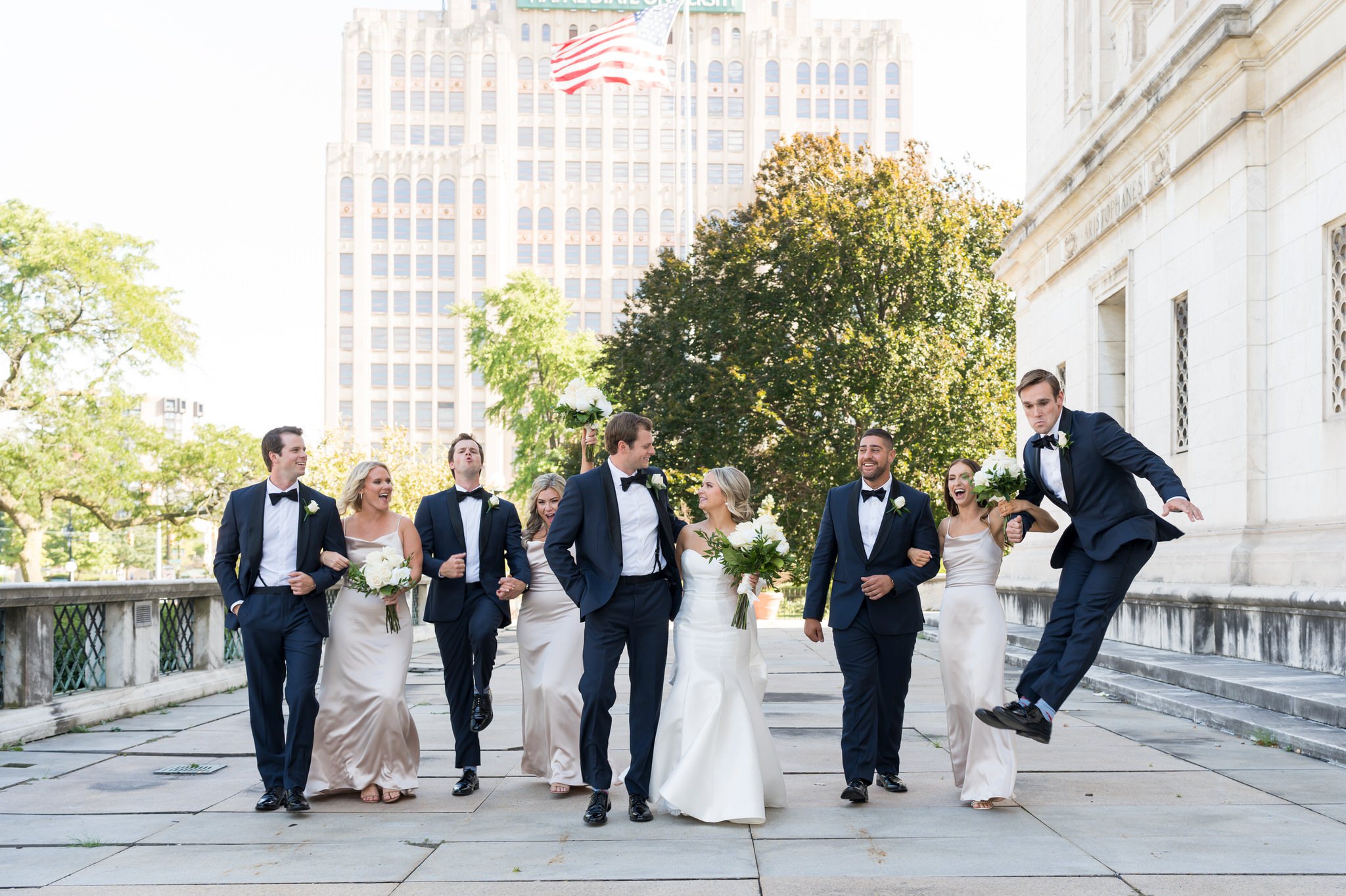 A bridal party walks and celebrates outside of the Detroit Public Library.  