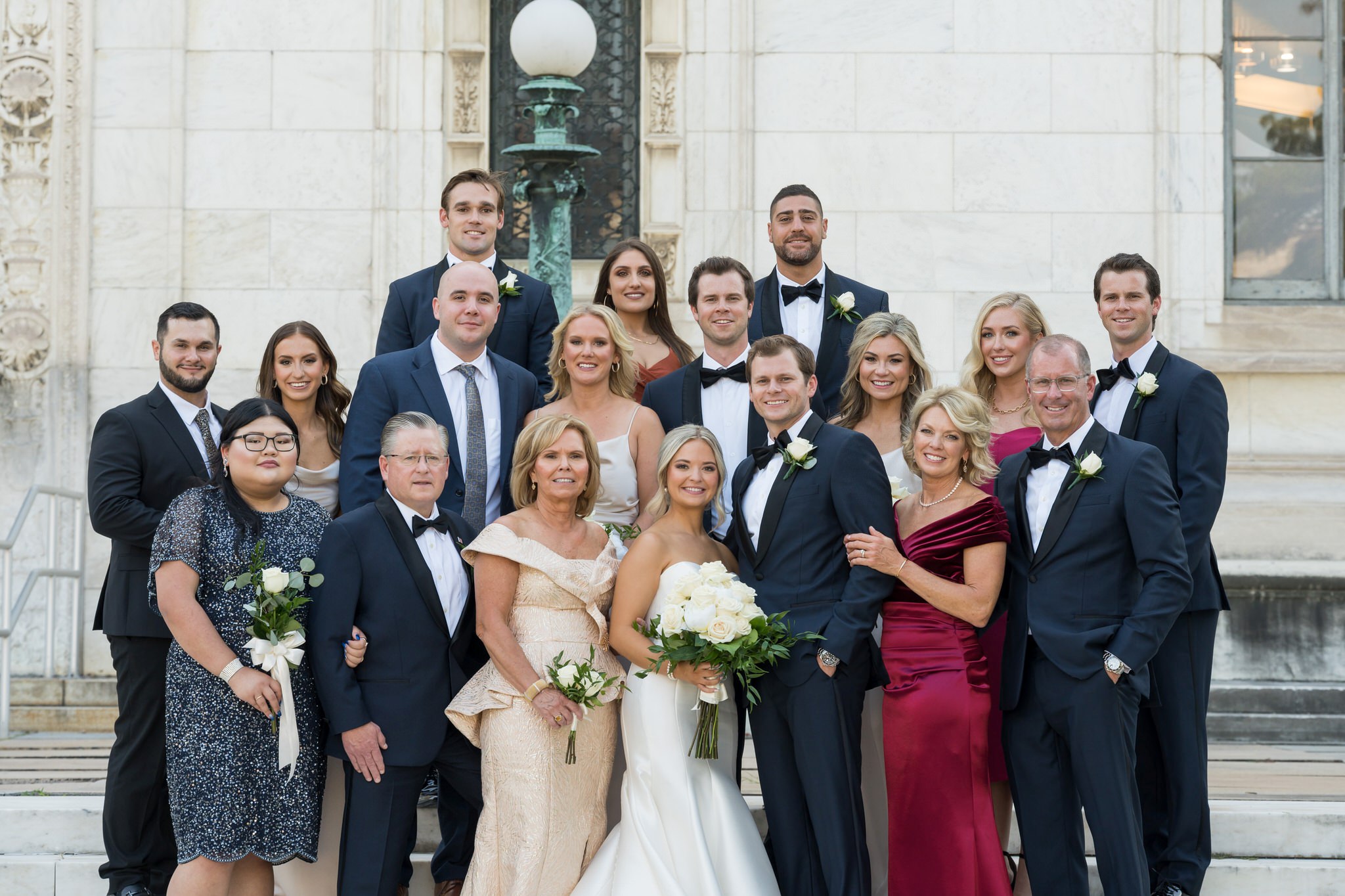 A big group wedding photo on the steps of the Detroit Public Library.  