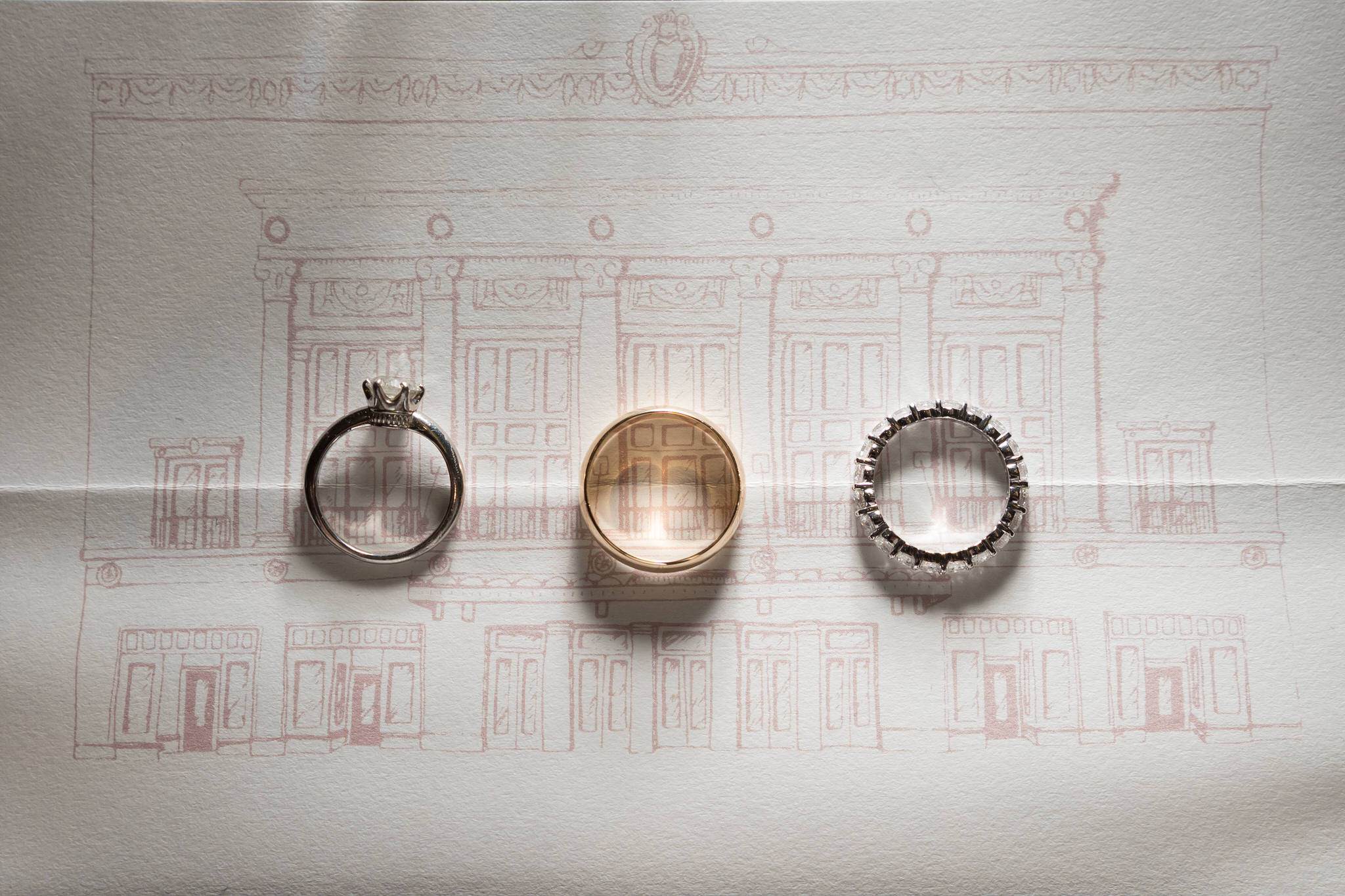 wedding rings on a paper drawing of Detroit's Orchestra Hall