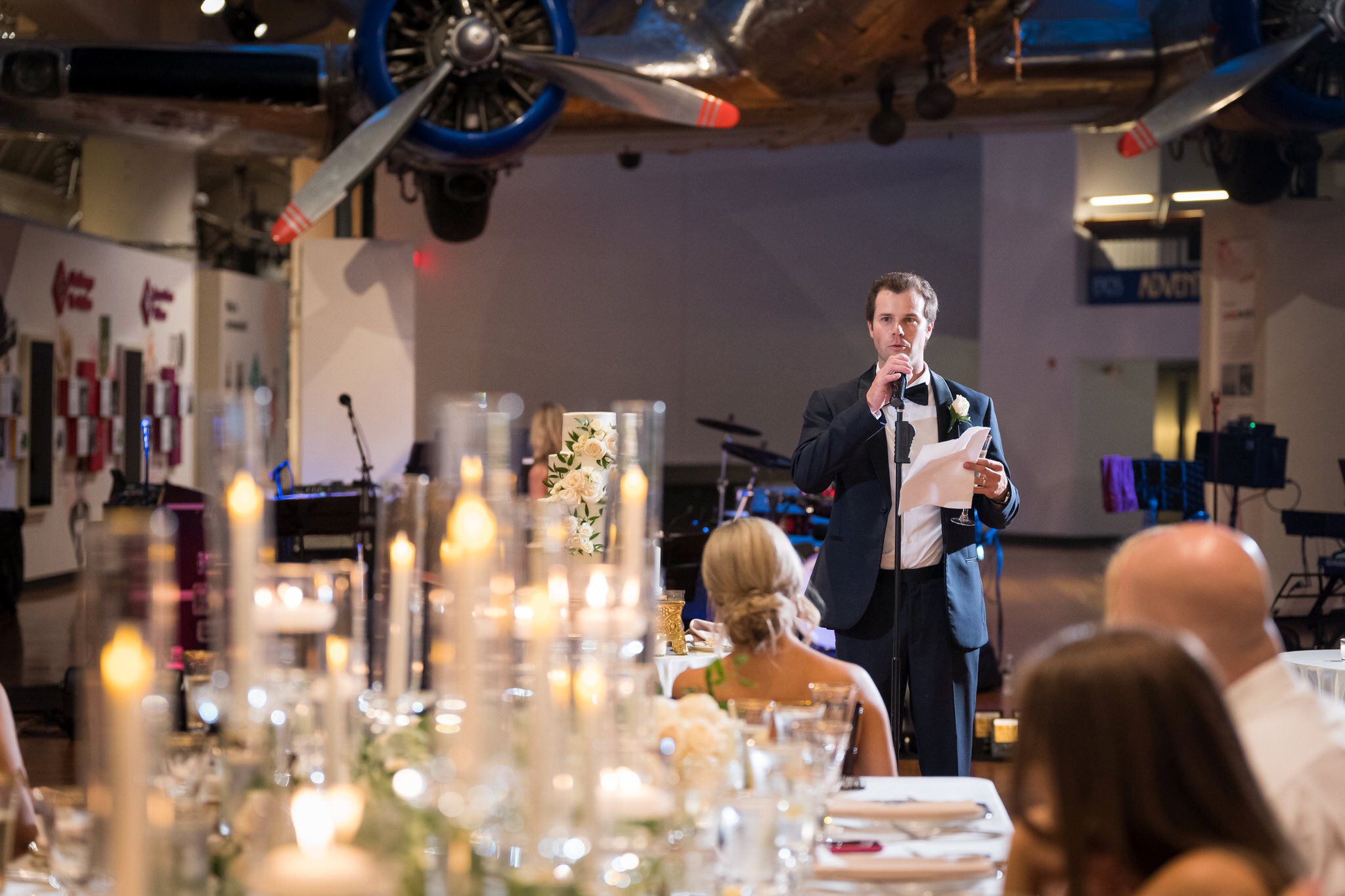 A groomsman gives a speech at a Henry Ford Museum wedding. 