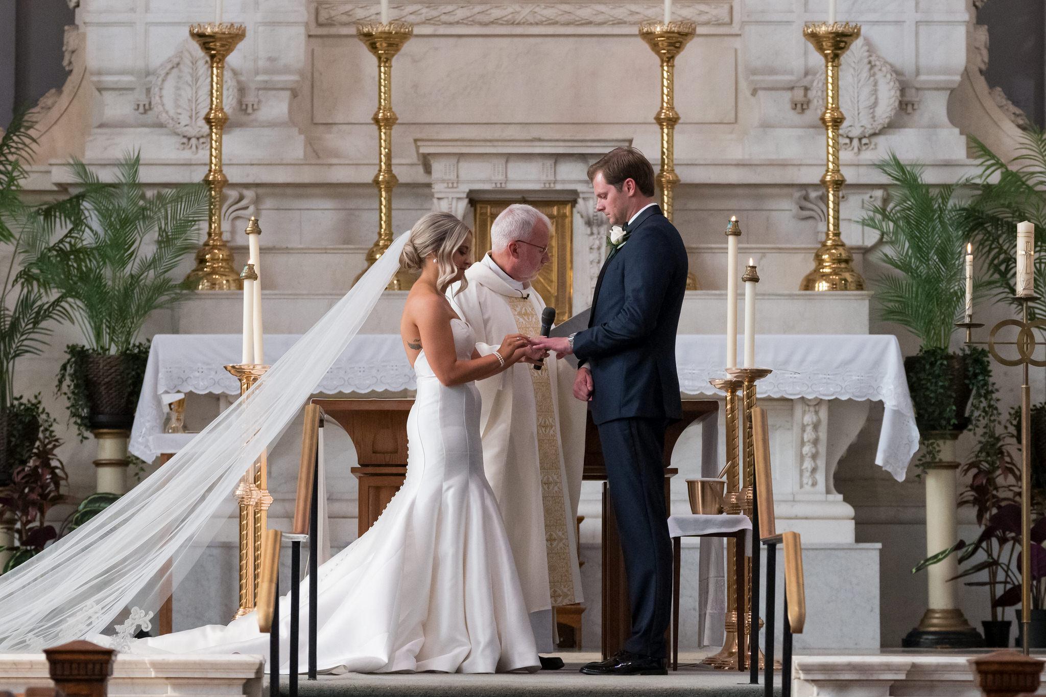 The exchange of rings during a wedding at Saints Peter and Paul Jesuit Church in Detroit.  