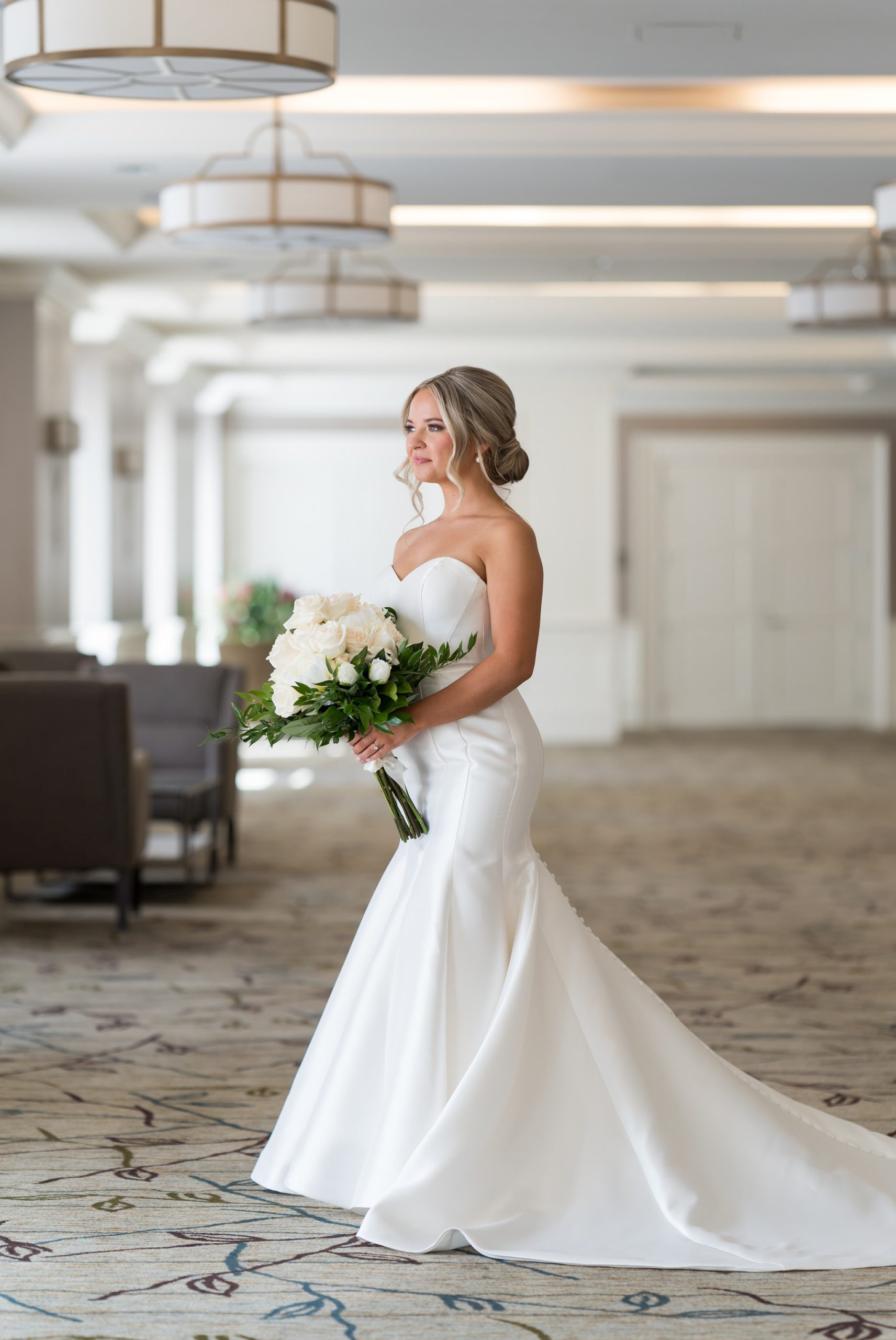 A bride holds her bouquet in the lobby of the Westin Book Cadillac on her wedding day.