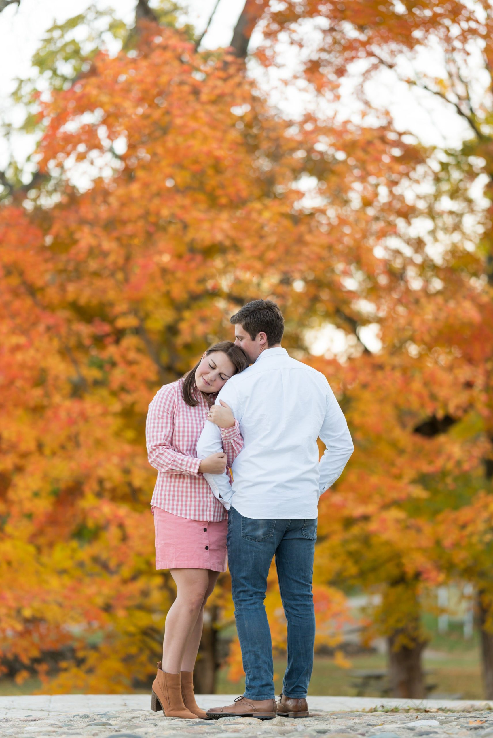 A couple quietly hugs each other at their fall engagement at Van Hoosen. 