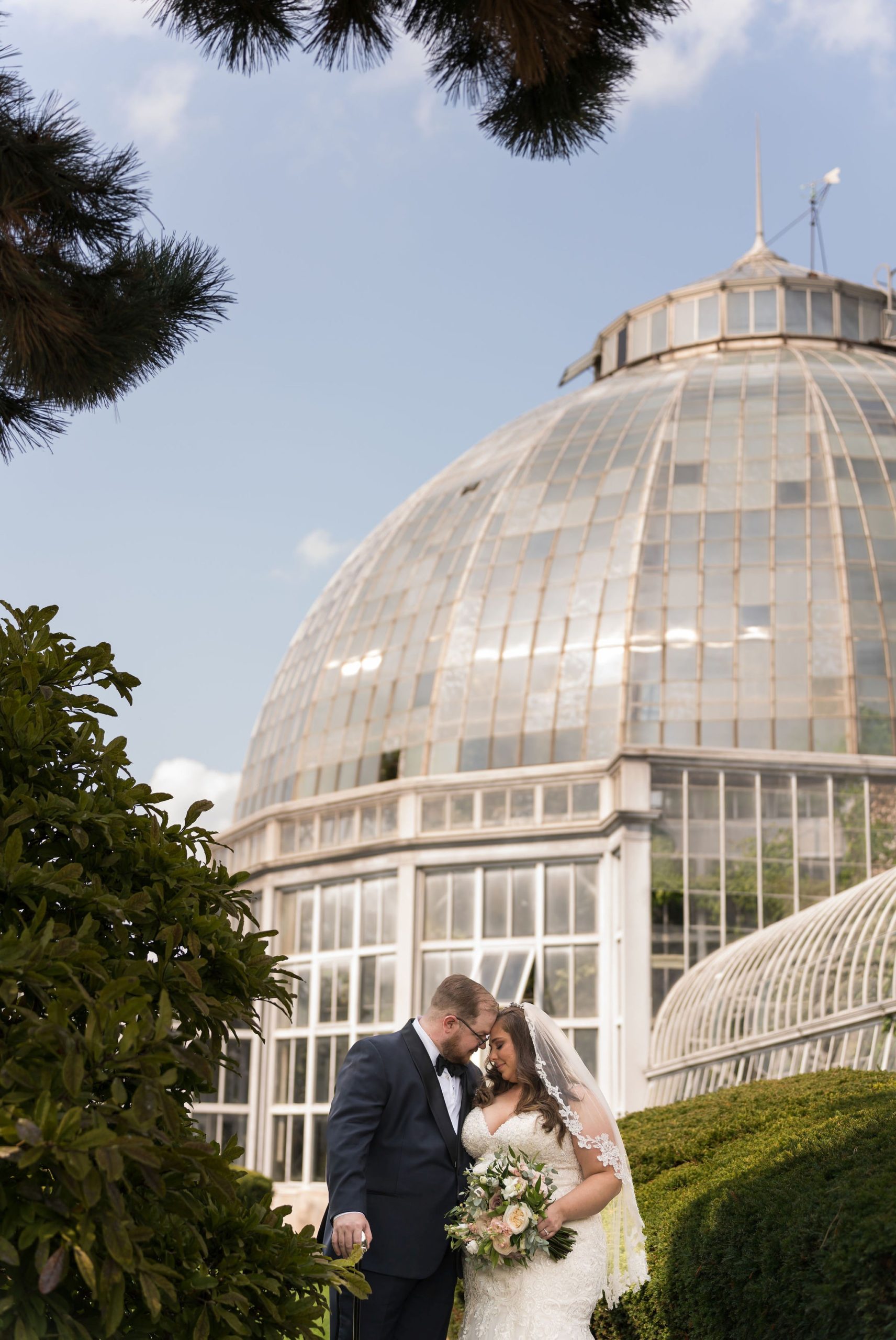 A wedding day portrait of a couple in front of the Conservatory on Belle Isle, Detroit. 