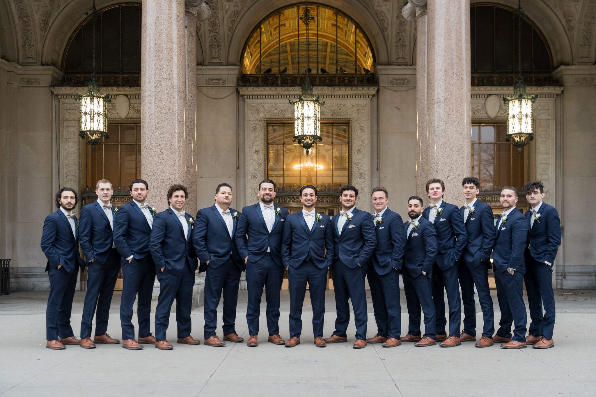 Groomsmen pose together at Cadillac Place