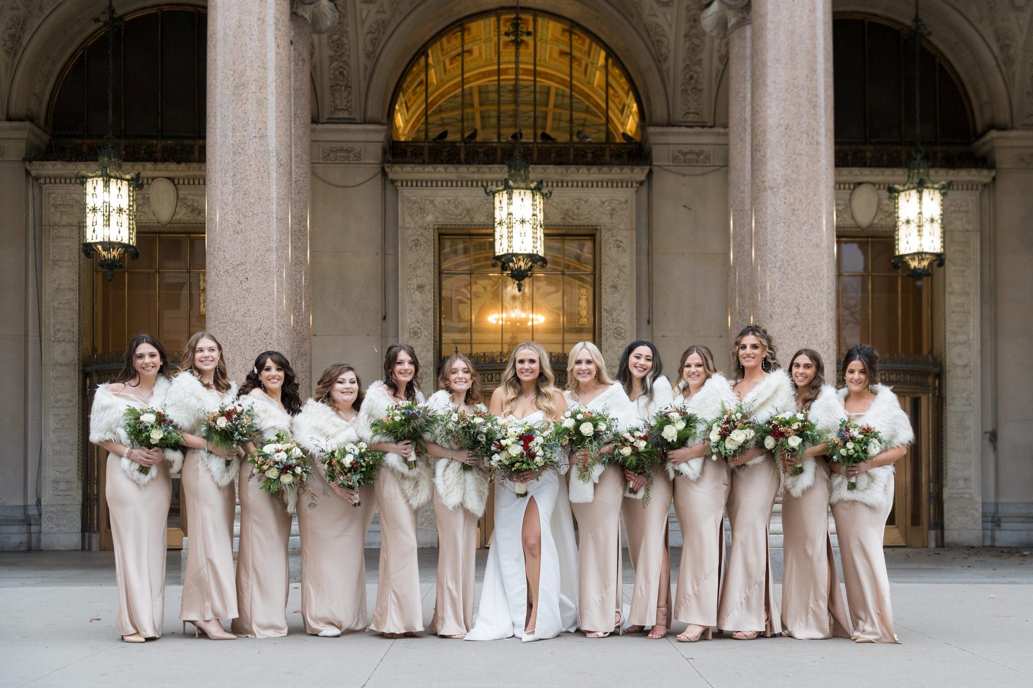Bridesmaids pose in a line at Cadillac Place in Detroit, MI.