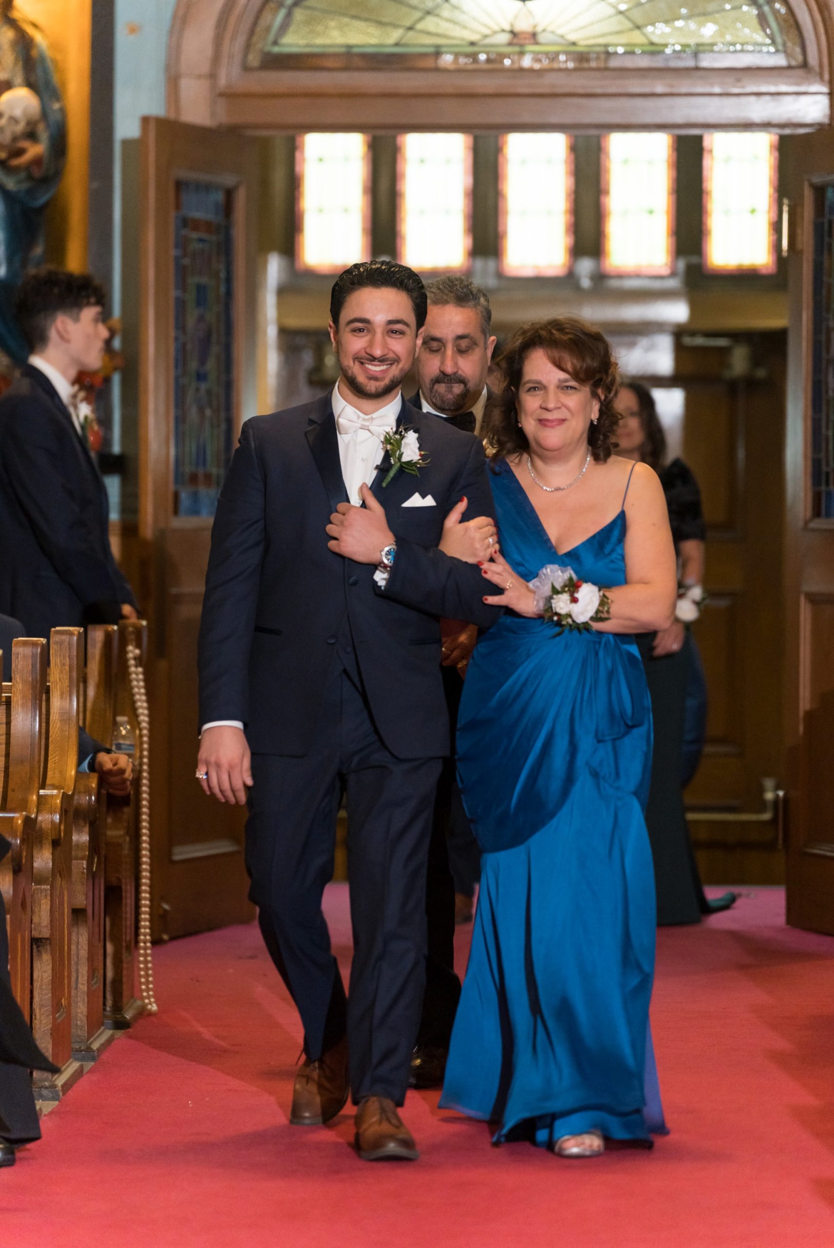 Mom and son walk down the aisle at Holy Family Catholic Church in Detroit.  