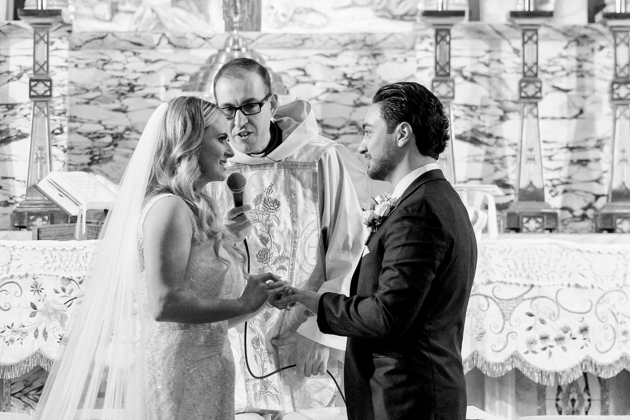 A bride and groom exchange vows at Holy Family Catholic Church in Detroit.