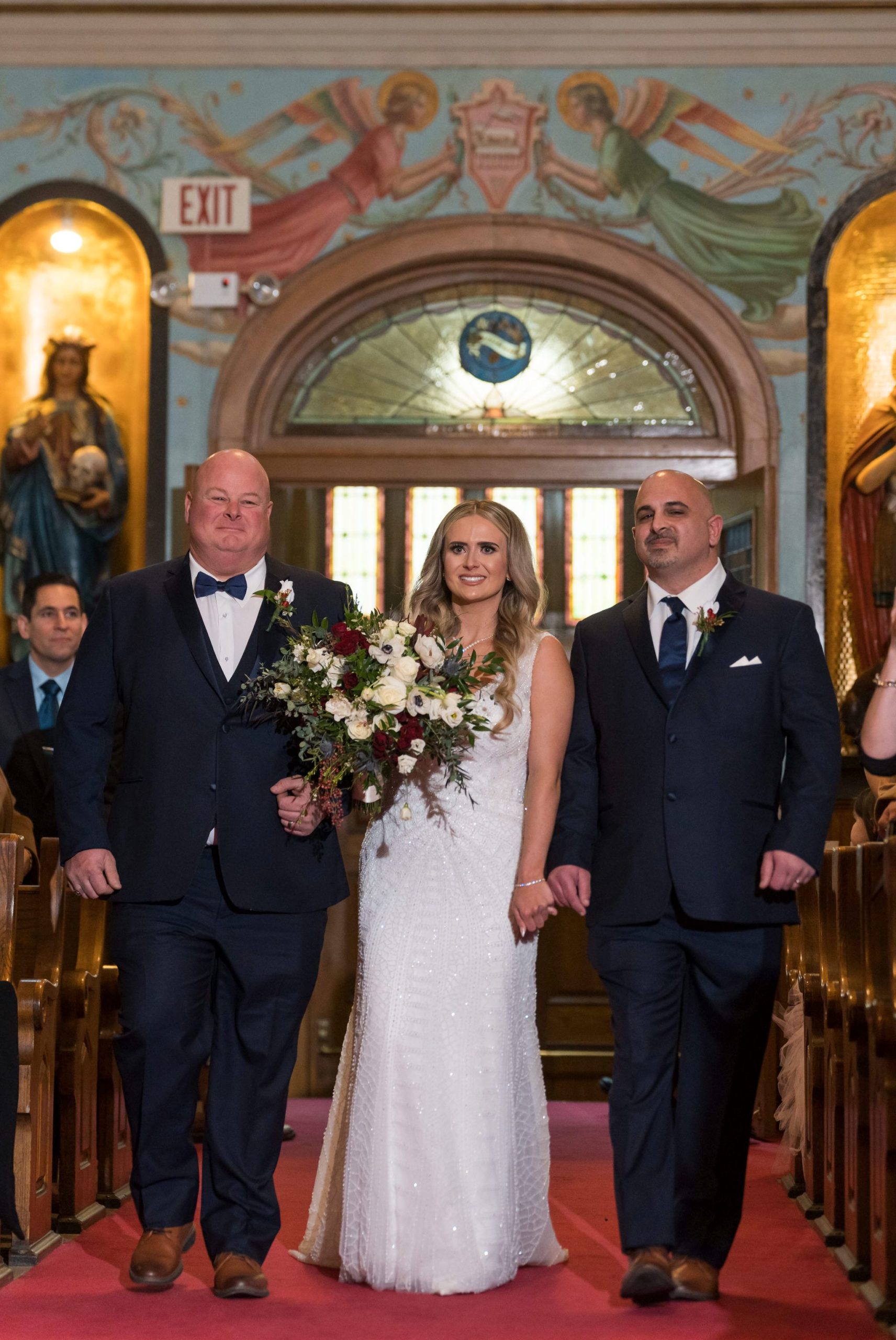 A bride is escorted down the aisle at Holy Family Catholic Church in Detroit. 