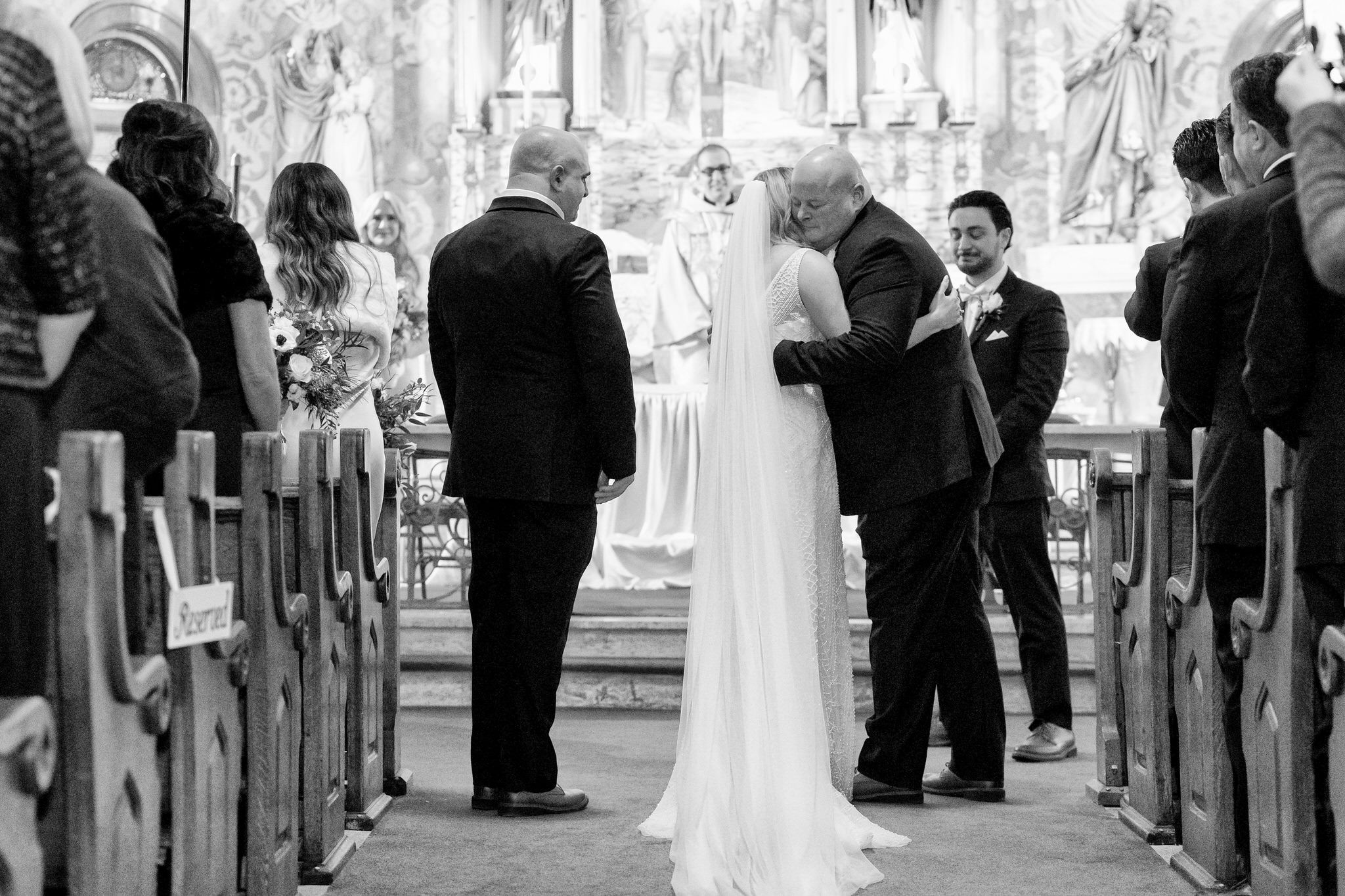 A bride hugs her father at the altar of Holy Family Catholic Church in Detroit. 