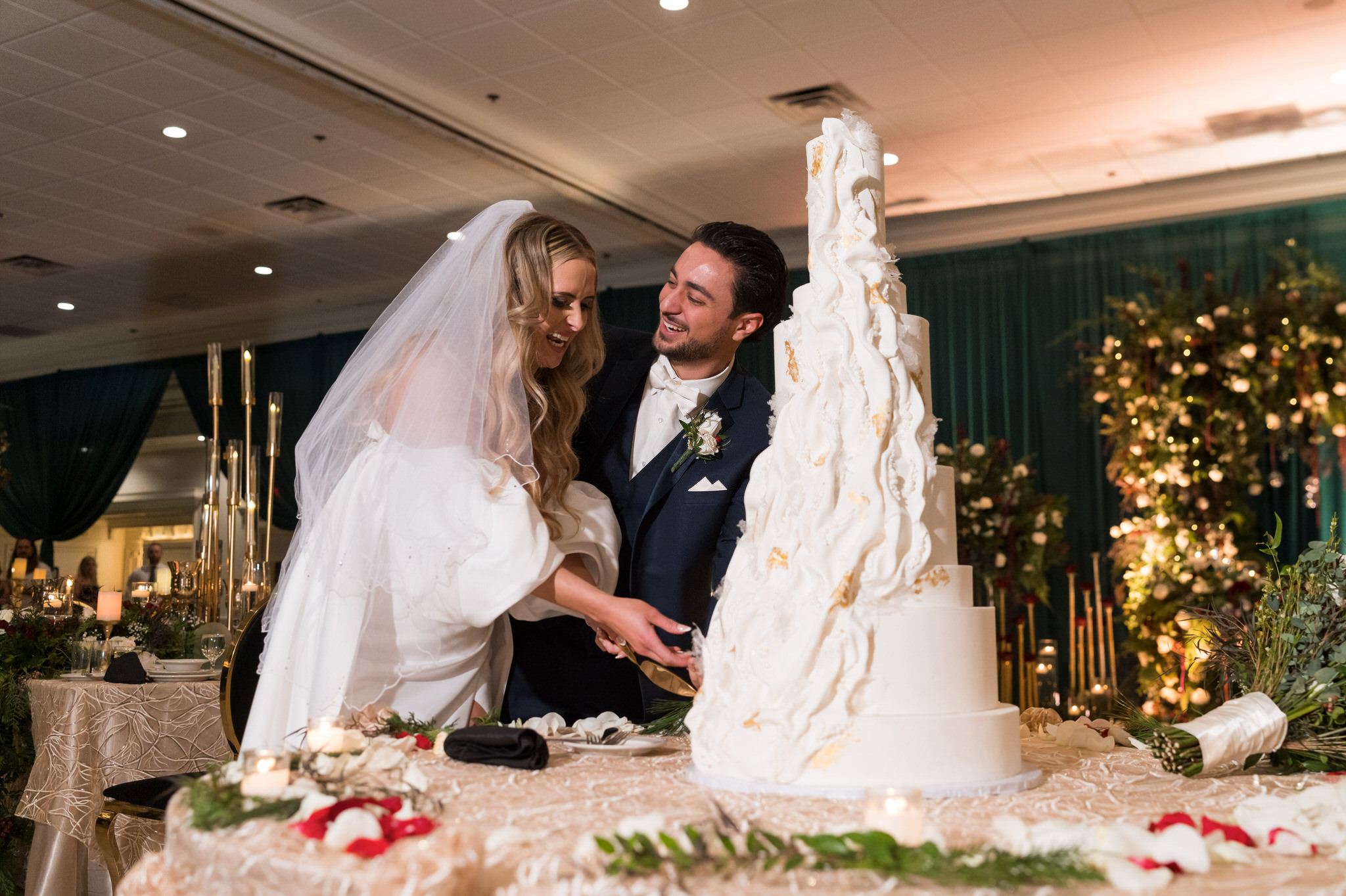 Bride and groom cut their cake at their Penna's of Sterling wedding reception