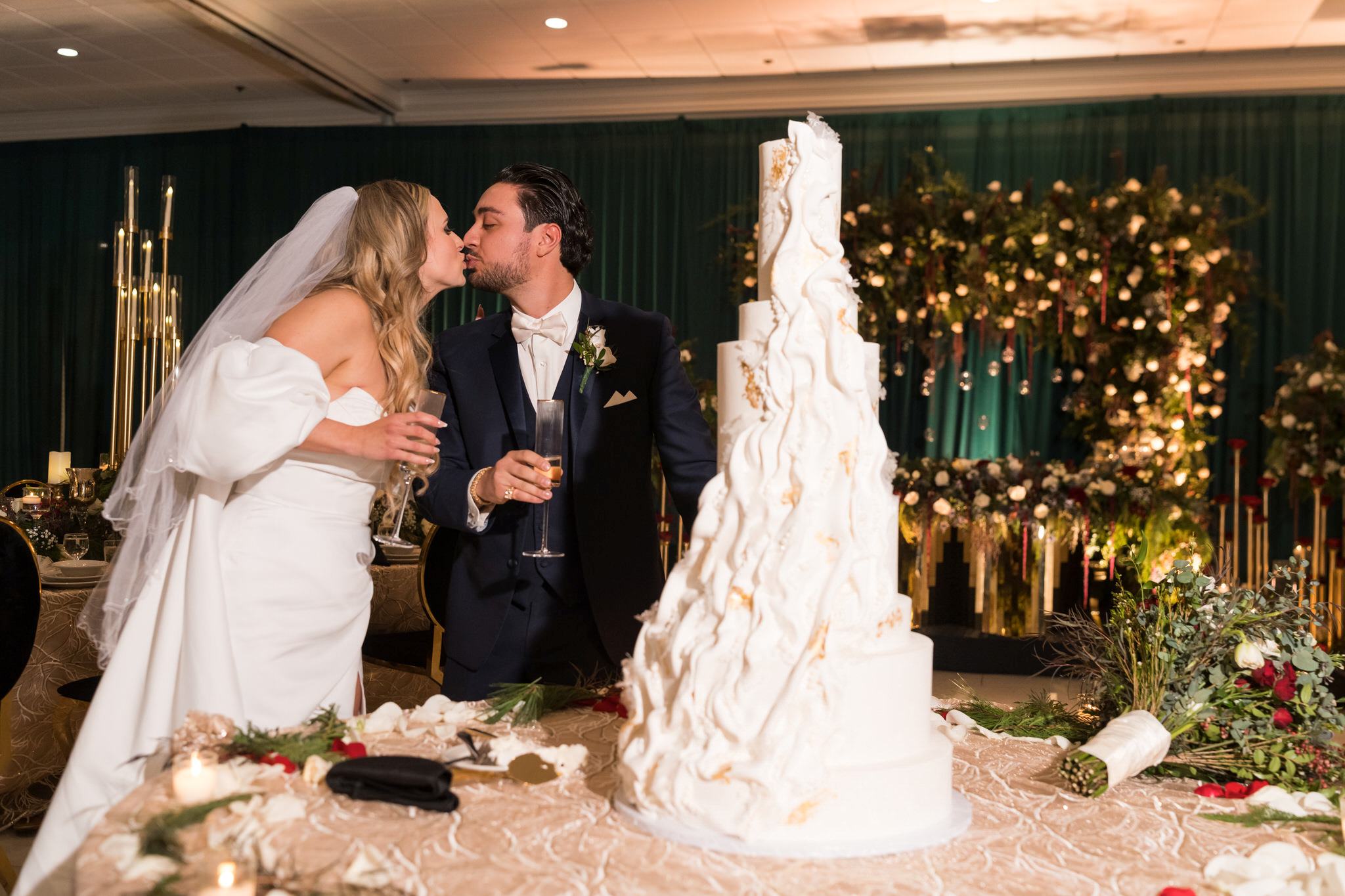 Bride and groom kiss after cutting their cake at their Penna's of Sterling wedding reception