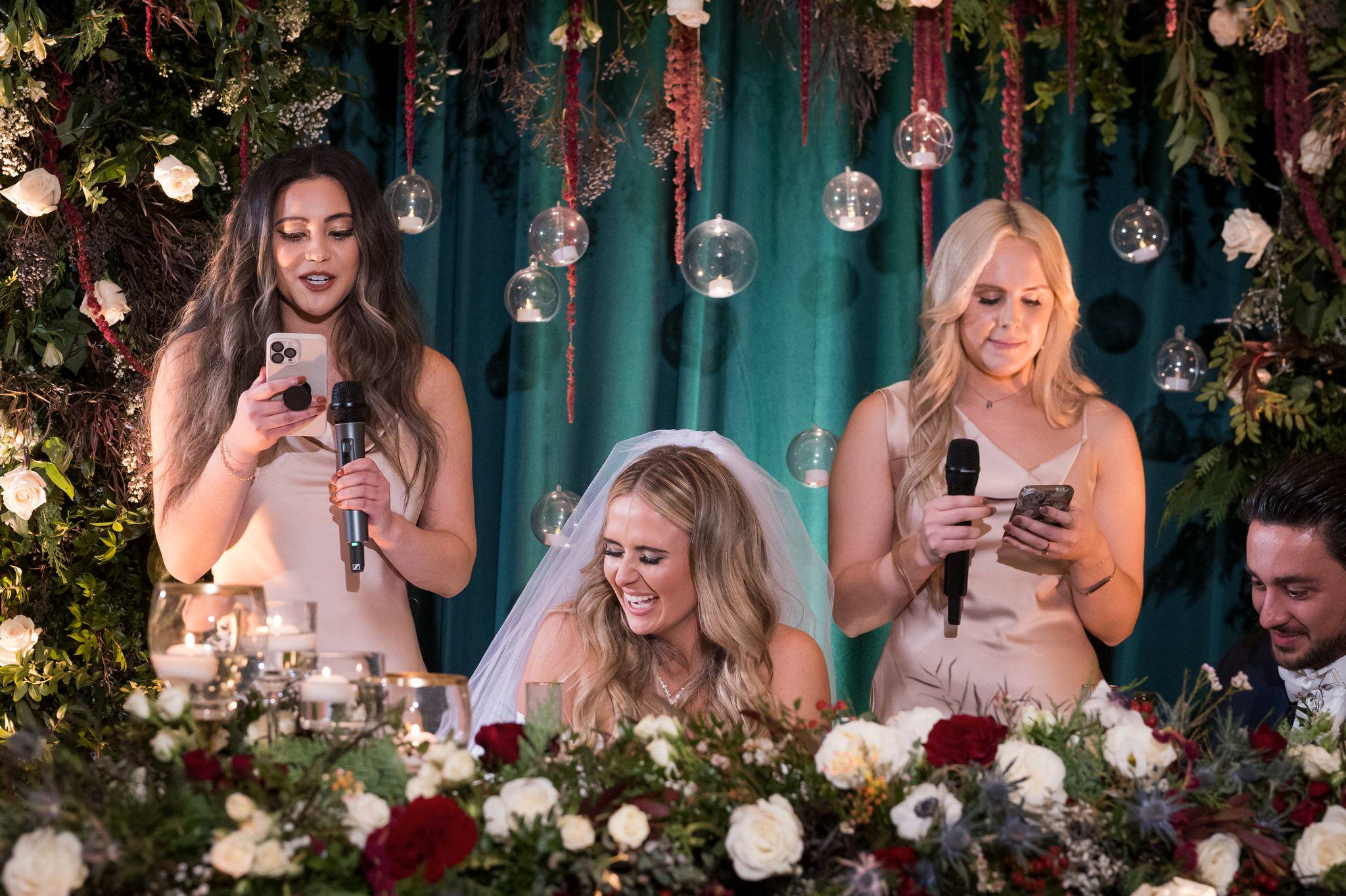 Two bridesmaids give a speech at a Penna's of Sterling wedding reception.  