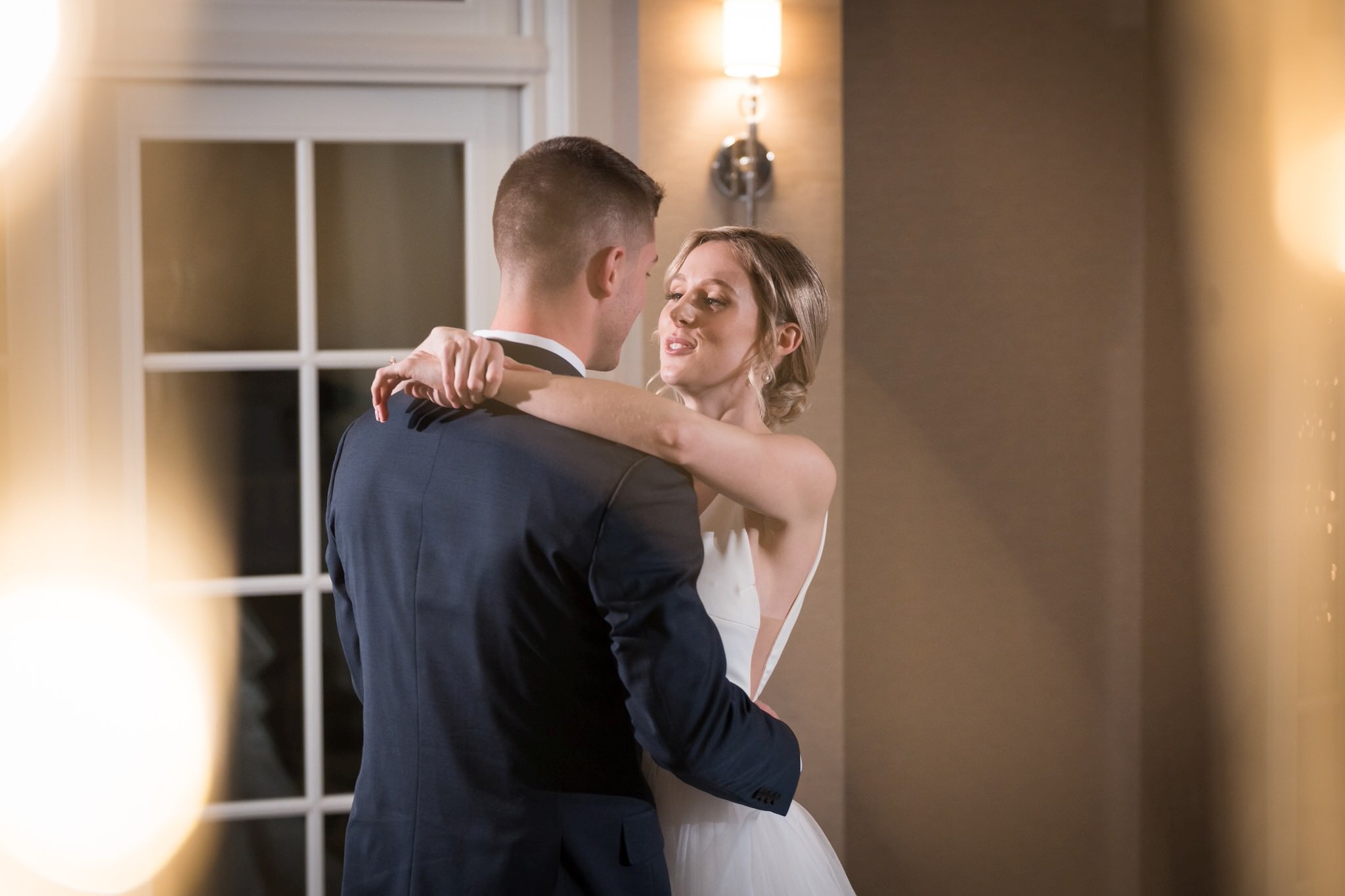 A bride and groom share their first dance at the Sagamore Room during their Bay Harbor wedding reception. 