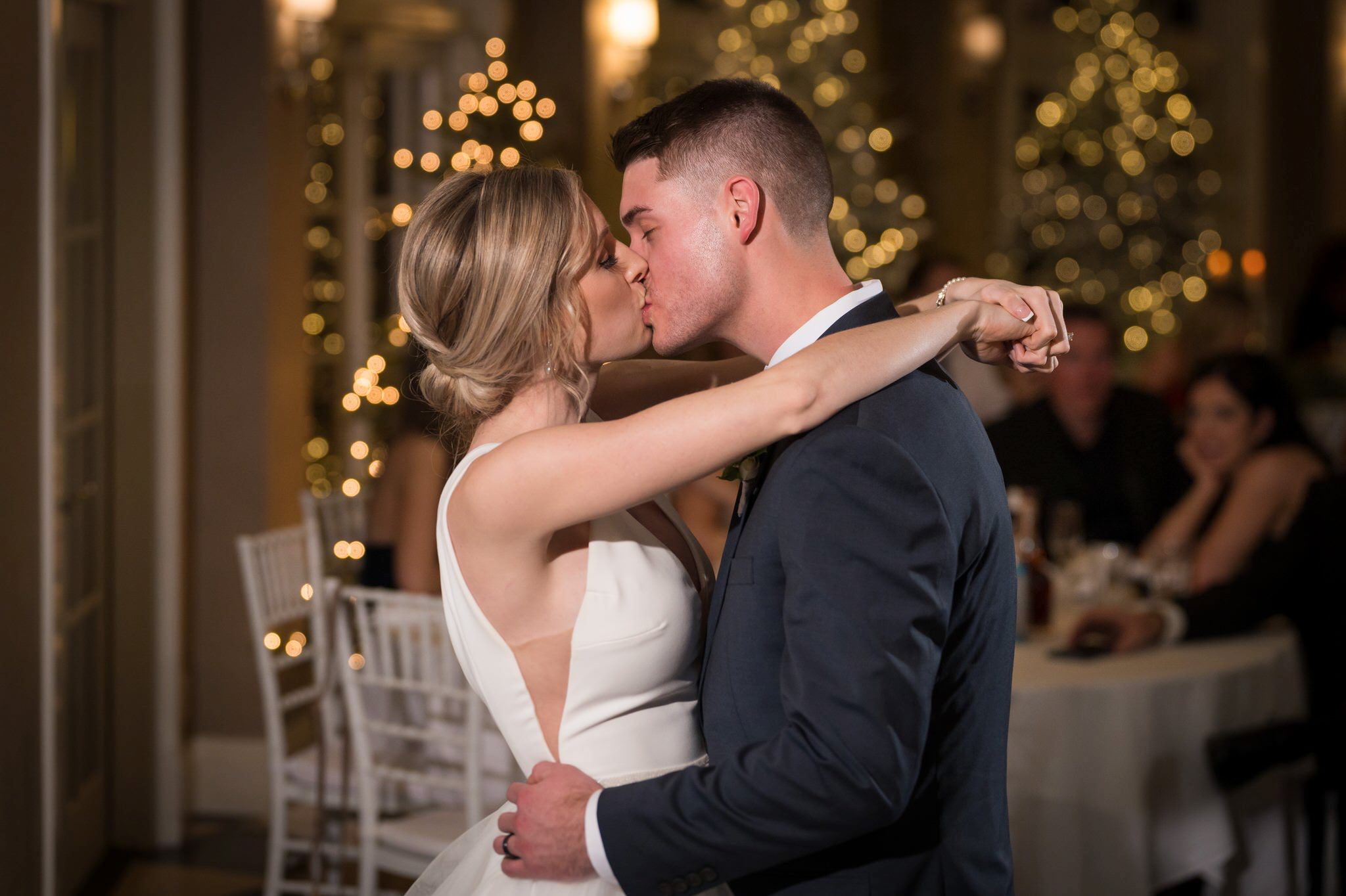 A bride and groom share  a kiss during their first dance at the Sagamore Room during their Bay Harbor wedding reception. 