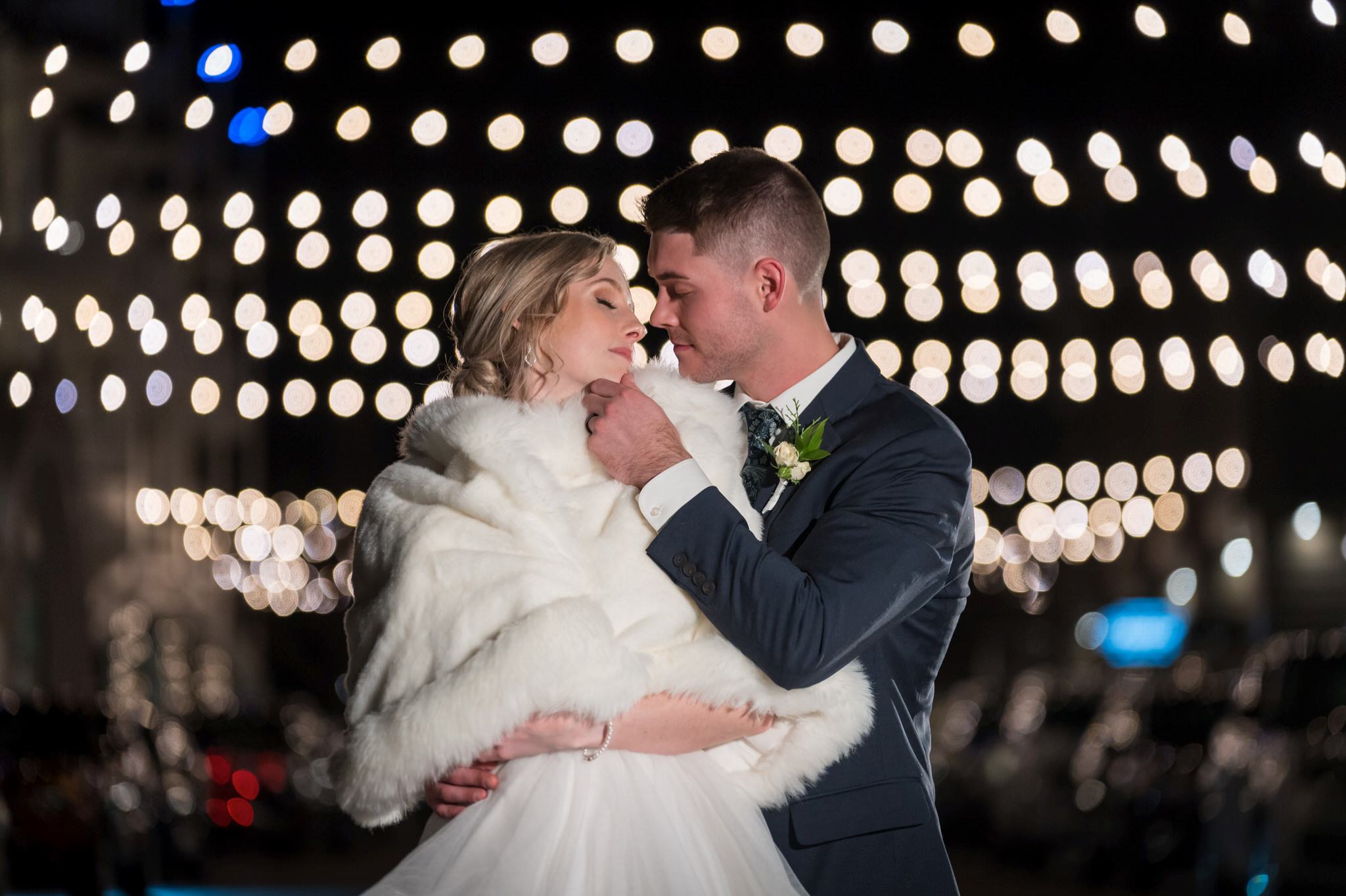 A night shot with twinkle lights in the background during a Bay Harbor wedding reception.