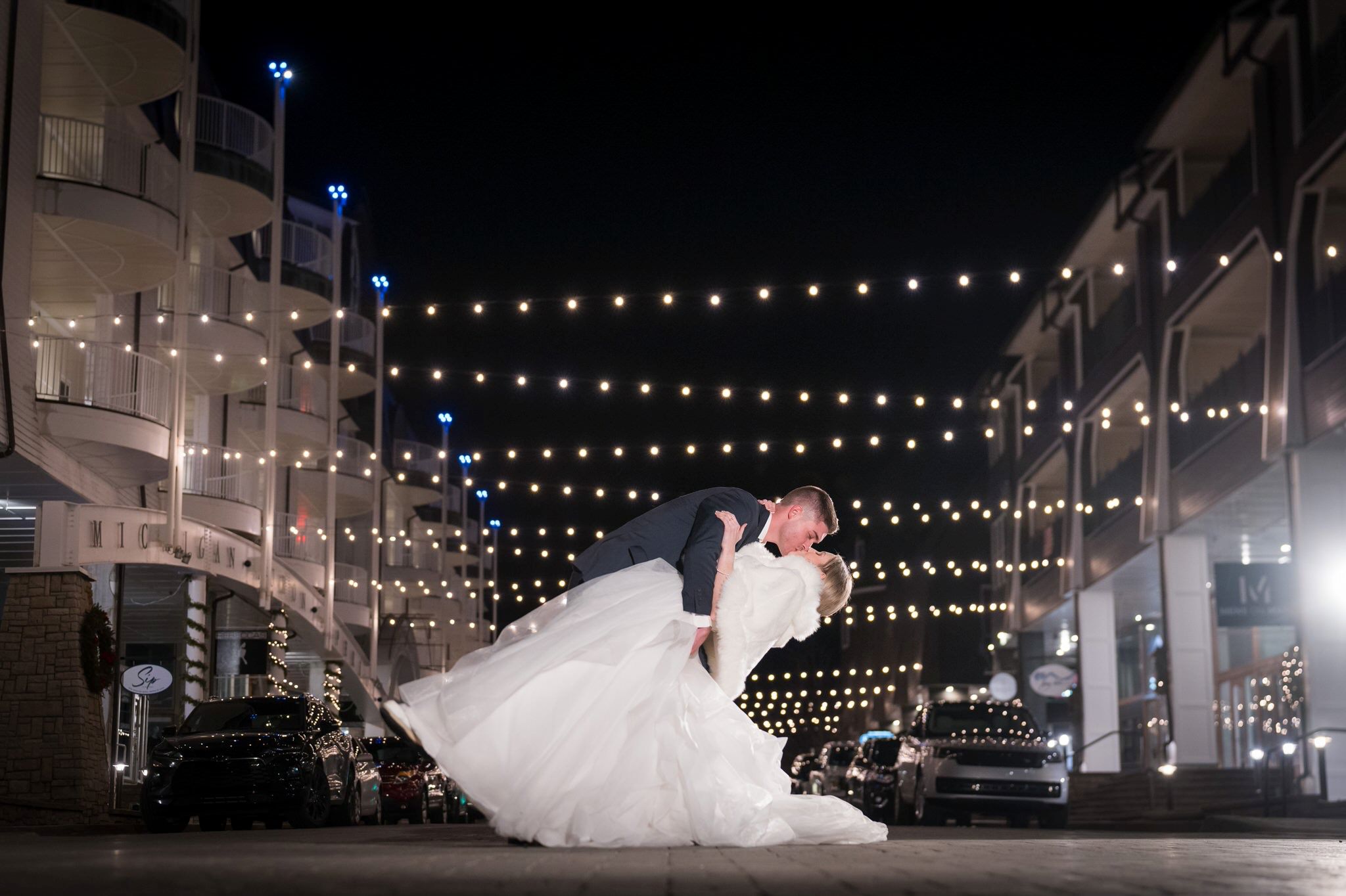 A night shot with twinkle lights in the background during a Bay Harbor wedding reception.