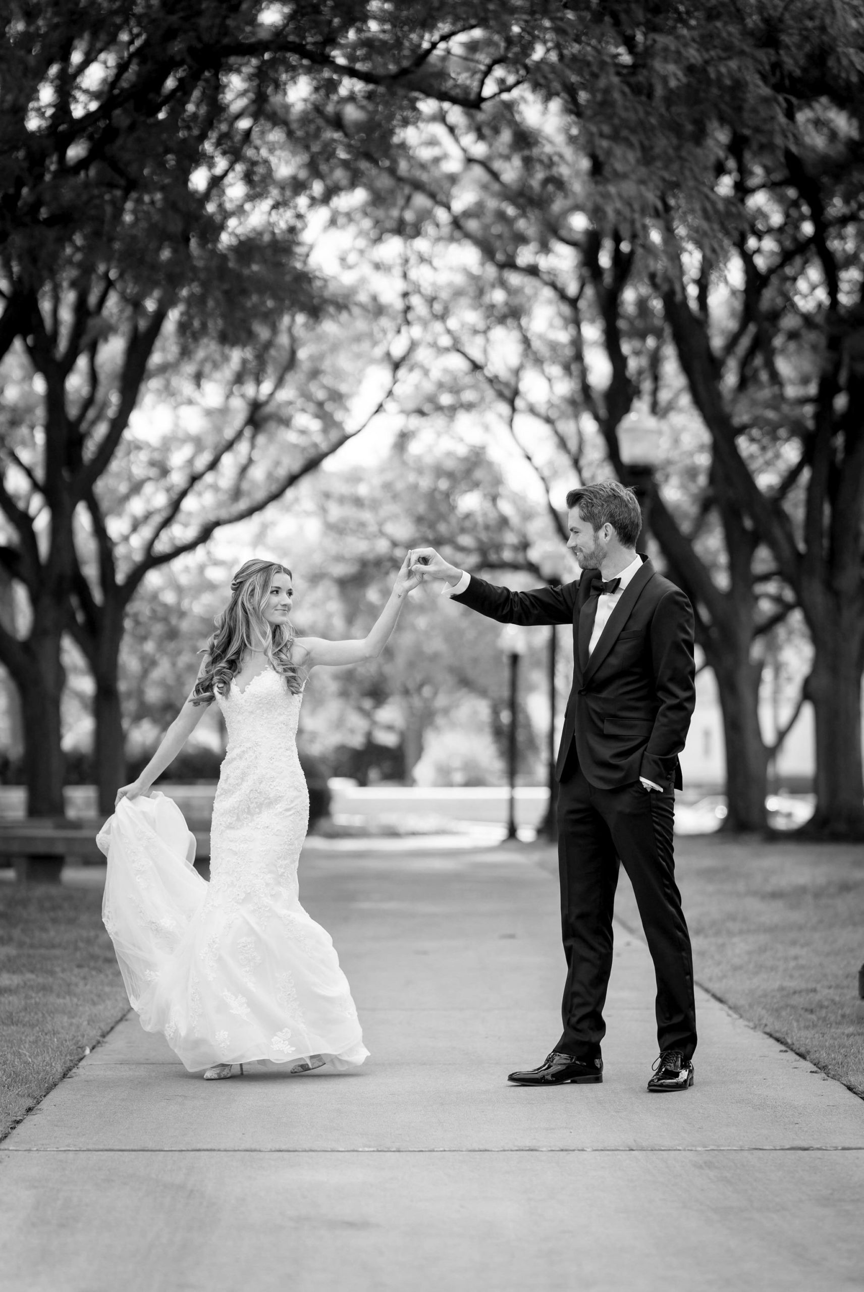 A bride twirls under the arm of her groom on her wedding day at the Detroit Institute of Art.