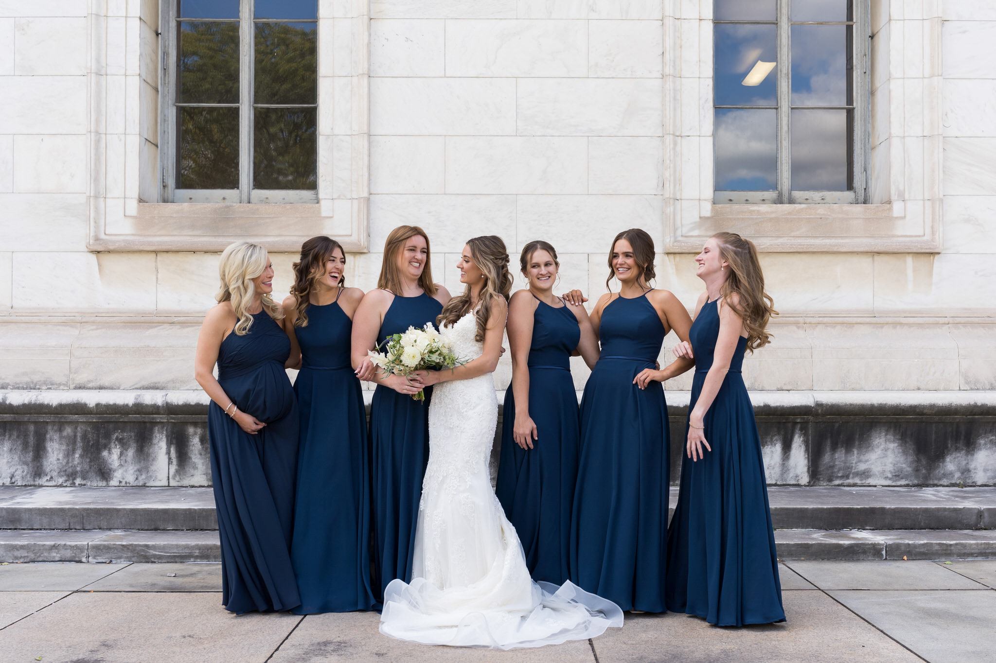 Bridesmaids pose outside of the  Detroit Public Library.