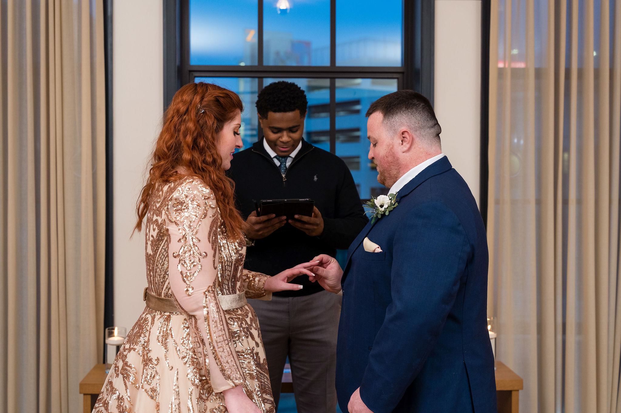 A couple marries and exhcange rings in a secret Detroit elopement in a room at the Shinola Hotel. 