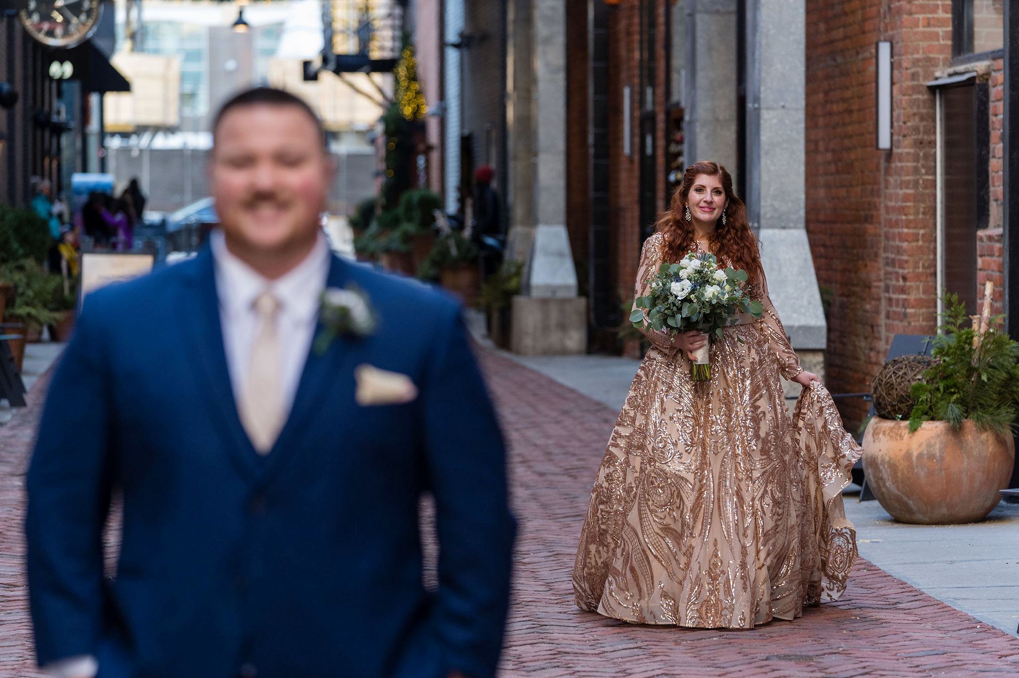 A bride approaches her groom for their first look in Parker's Alley, Detroit. 