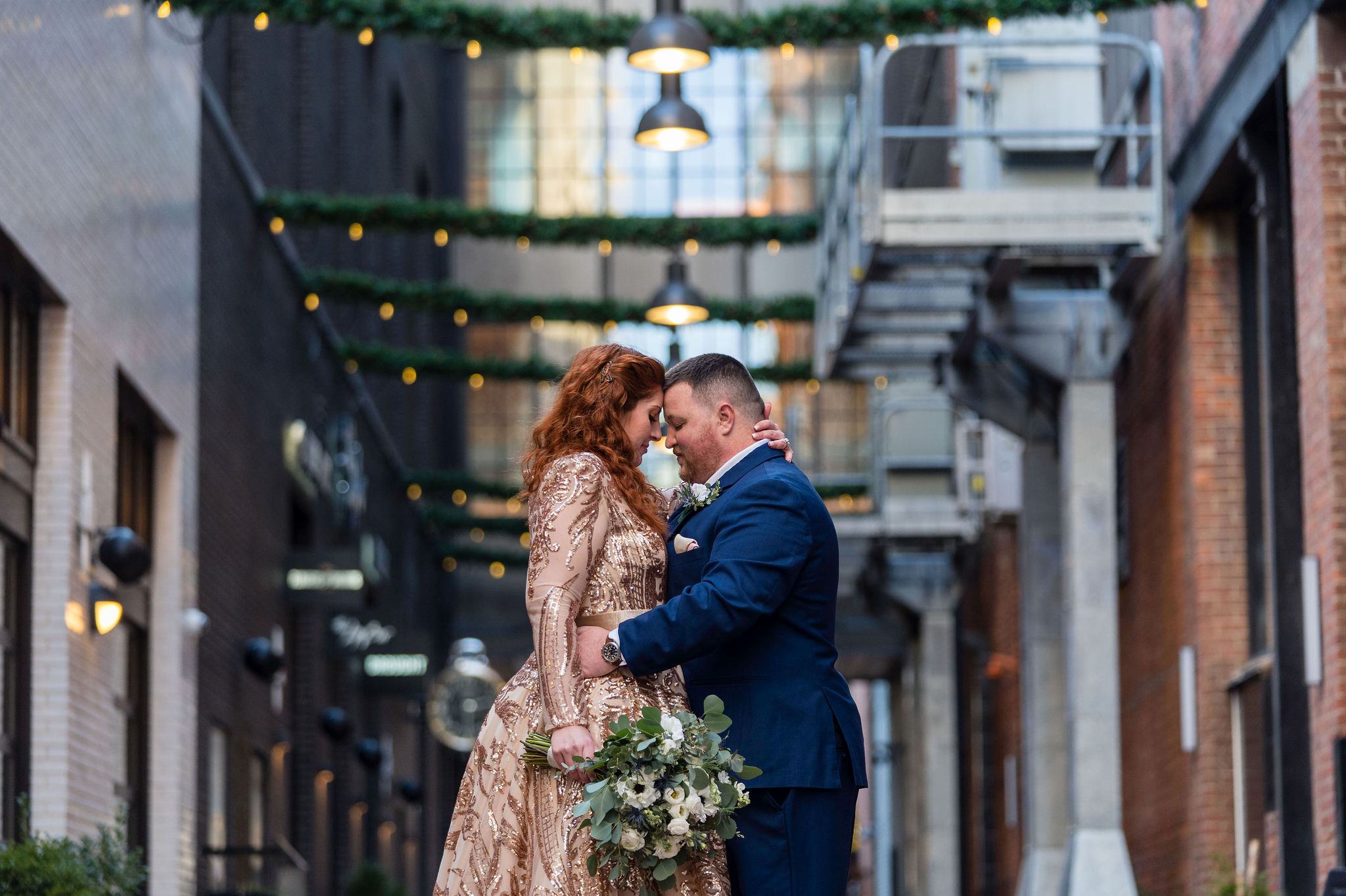 A couple poses, foreheads together and hugging, in Parkers Alley during their secret Detroit elopement. 