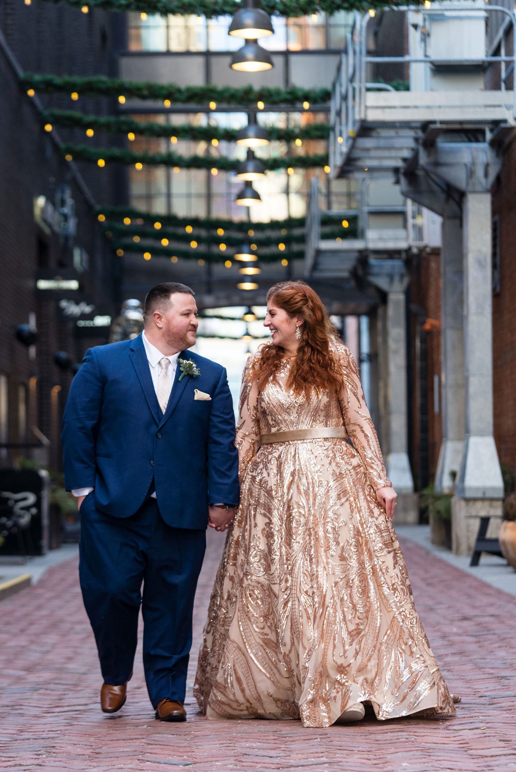 Holding hands, a couple walks down Parker's Alley on their Detroit elopement day.  