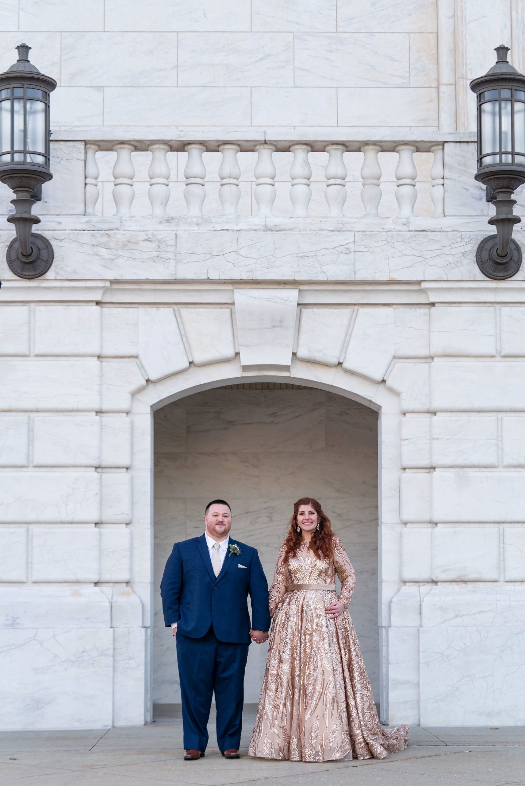 A couple poses in an archway at the Detroit Institute of Art.  