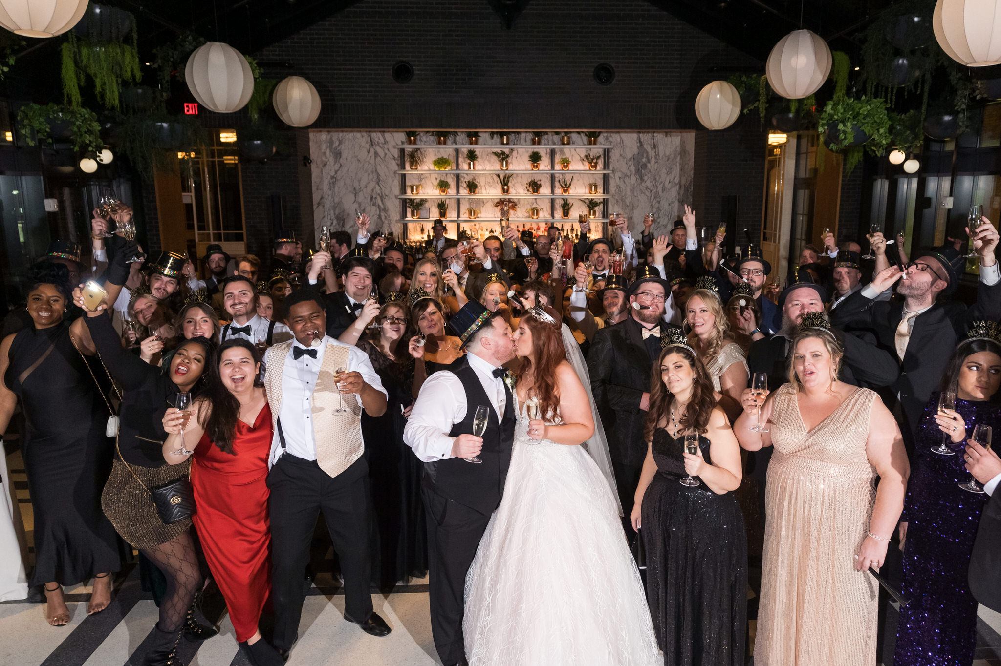 A large group of people gather at a New Year Eve Shinola Hotel wedding. 