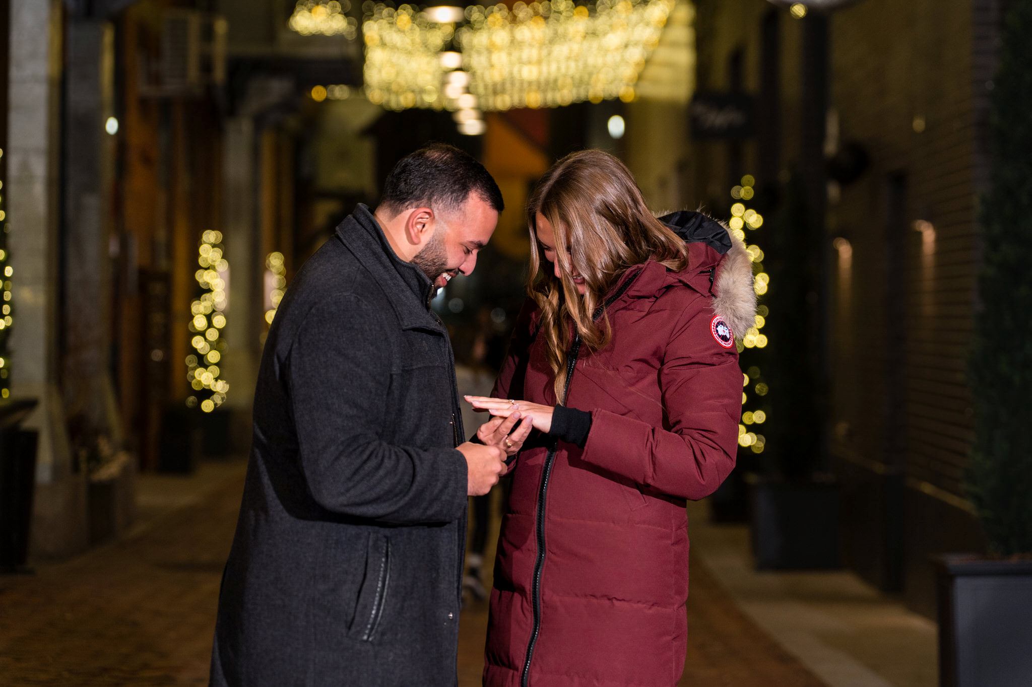A fiance looks at her new ring at their Parker's Alley proposal in Detroit.  